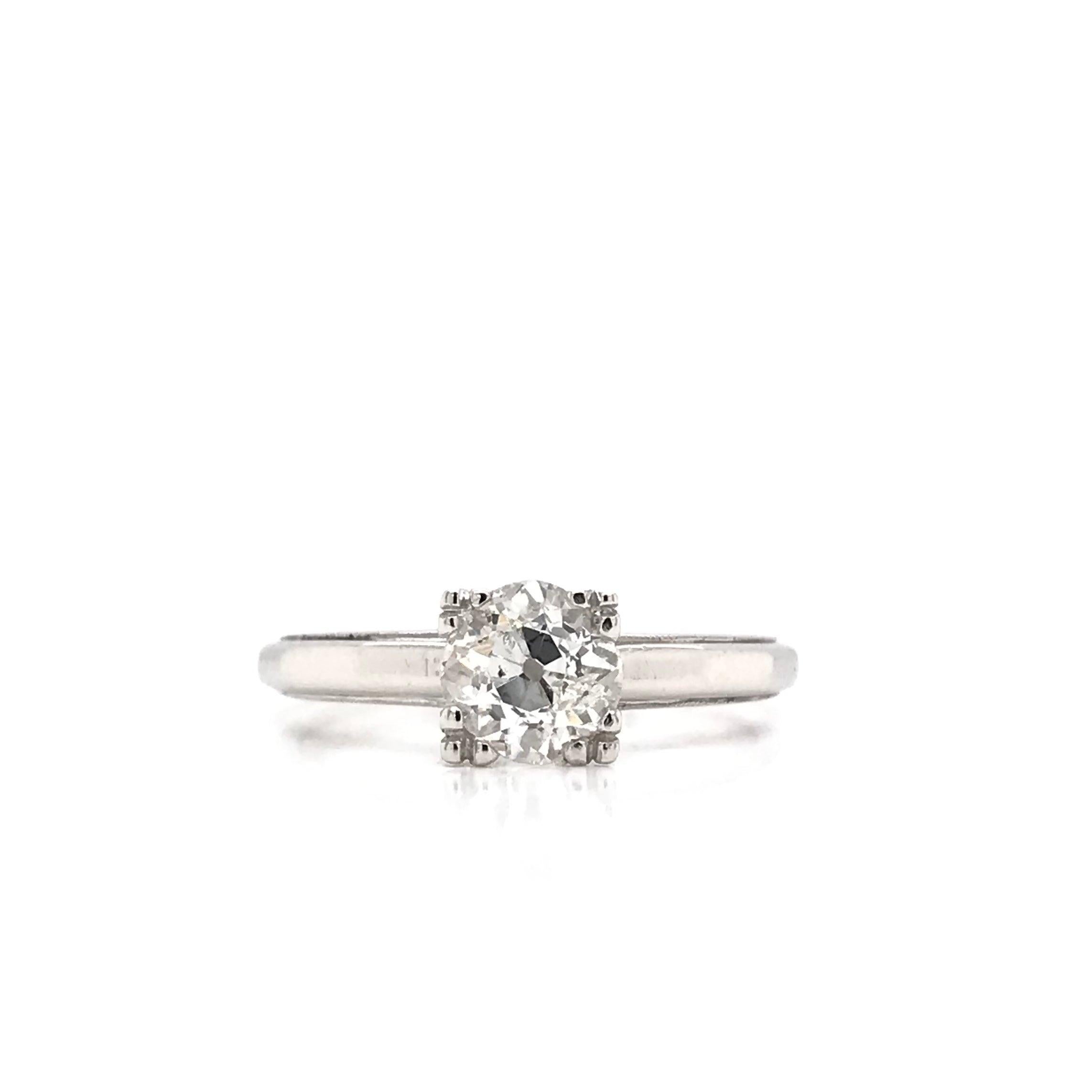 This platinum ring is an estate piece. This solitaire style ring features an antique Old Mine cut diamond in the center. Old Mine cut diamonds are often times similar to the modern cushion cut diamond. The diamond measures approximately 0.88 carats