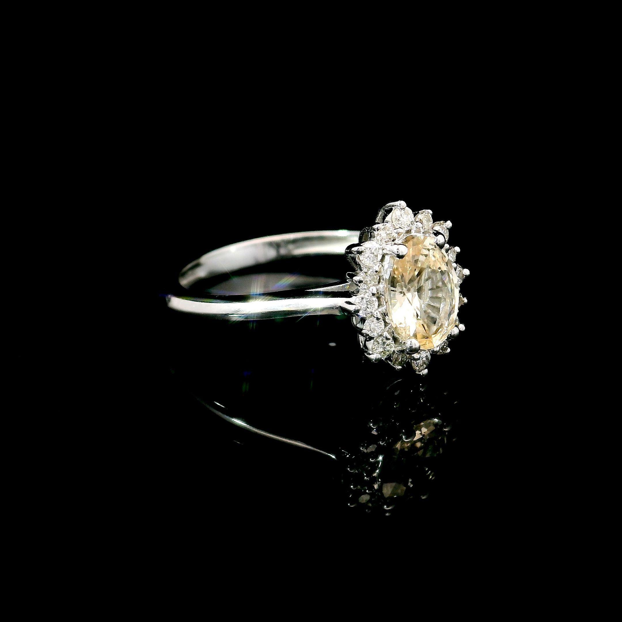 18kt white gold Sapphire Ring
  
  Gold colour & Carat: White gold 18kt
  Weight: 2.79 grams
  
  Set with-
  Stone type: Sapphire
  Shape: Oval
  Carat: 0.88 ct
  Colour: Light yellow Sapphire
  
  Surrounding Stones: Diamonds
 1) White Diamonds
 