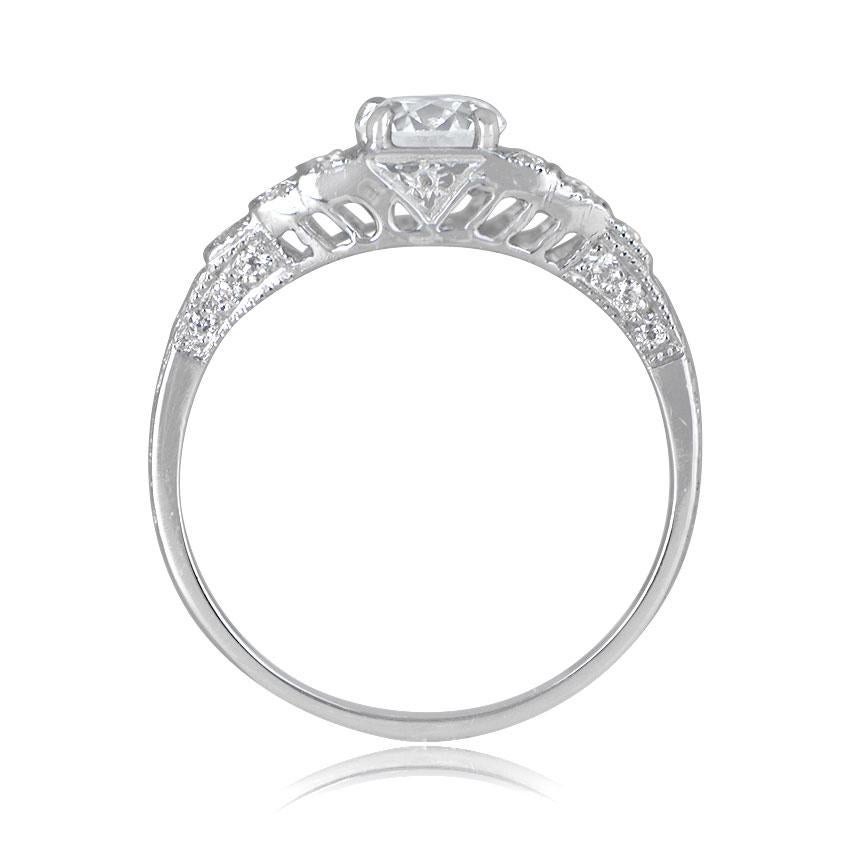 A dainty engagement ring highlighting a 0.88ct old European cut diamond, K color, and SI1 clarity. The shoulders elegantly slope towards the center, adorned with three sections set with diamonds. Delicate openwork filigree milgrain adorns the