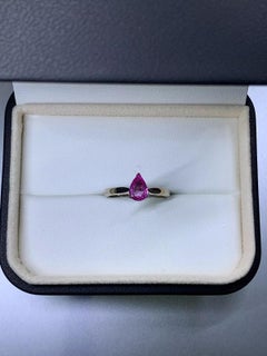 0.88ct Pink sapphire pear shaped solitaire engagement ring in 18ct white gold.