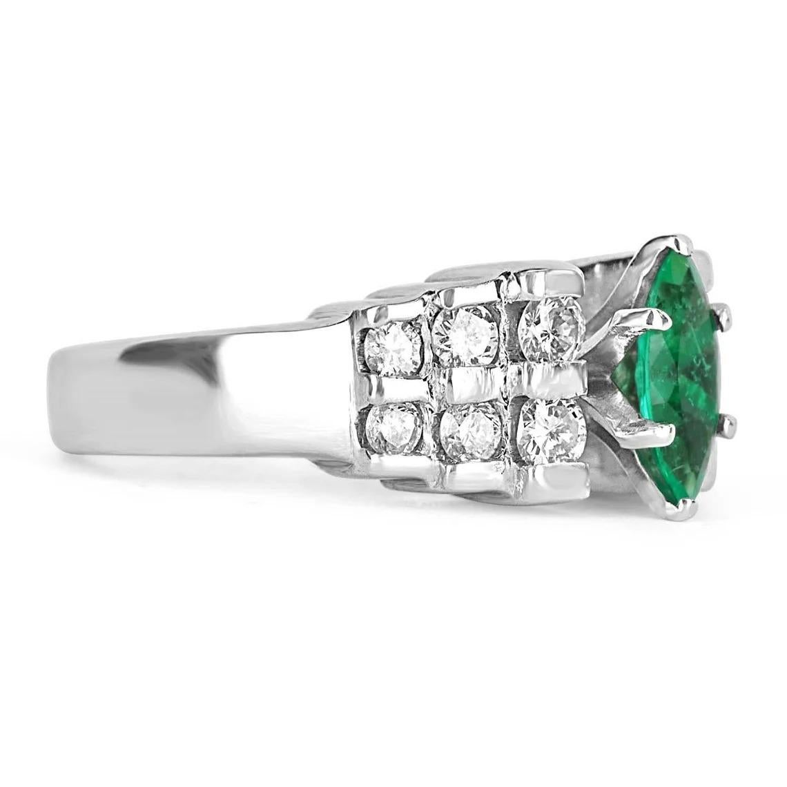 Displayed is a stunning emerald marquise and diamond ring. The center gemstone is an emerald marquise handset in a six-prong setting that allows for a full view of the emerald. Brilliant round diamonds are channel set on the shank of the ring and