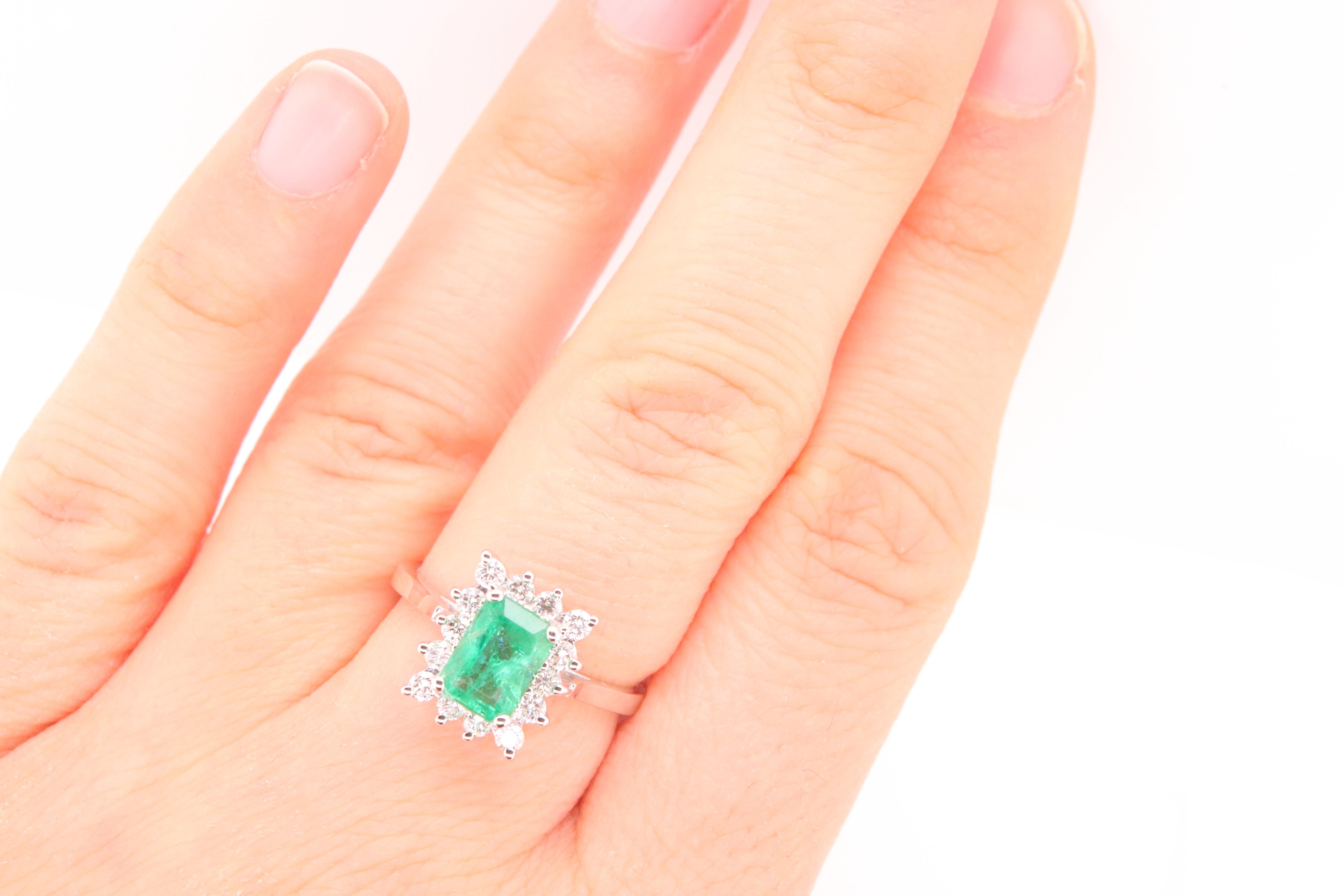 Material: 14k White Gold 
Center Stone Details: 1 Emerald Cut Emerald at 0.89 Carats - Measuring 7 x 5 mm
Diamond Details: 5 Brilliant Round Diamonds at 0.35 Carats - Clarity: SI / Color: H-I
Ring Size: 5.5. Alberto offers complimentary sizing on