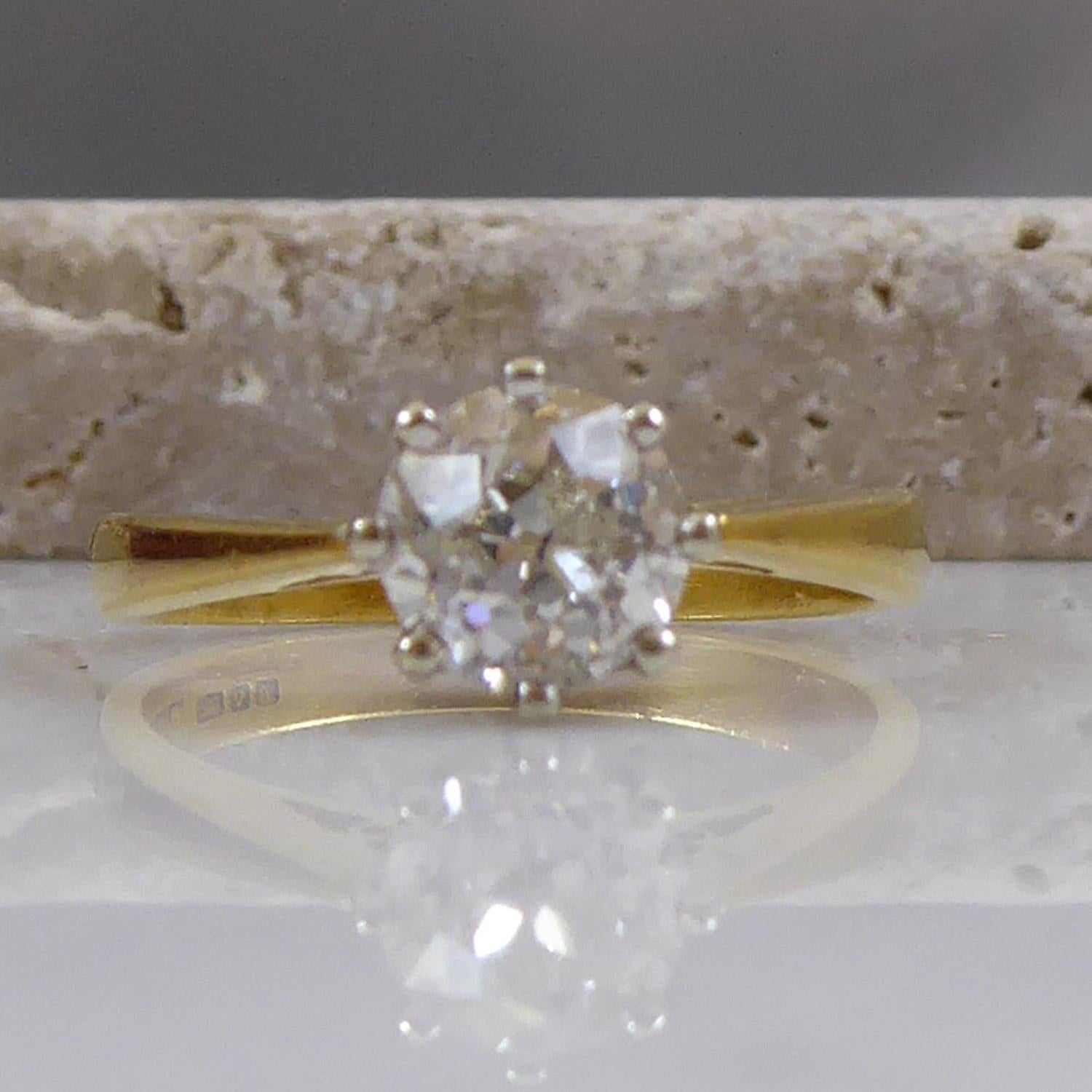 An antique old cut diamond set into a vintage solitaire mount hallmarked 1994.  The old European cut diamond measures approx. 5.72mm to 5.86mm x 4.05mm deep and it eight claw set to a white rex style mount with white underbezel to tapering yellow