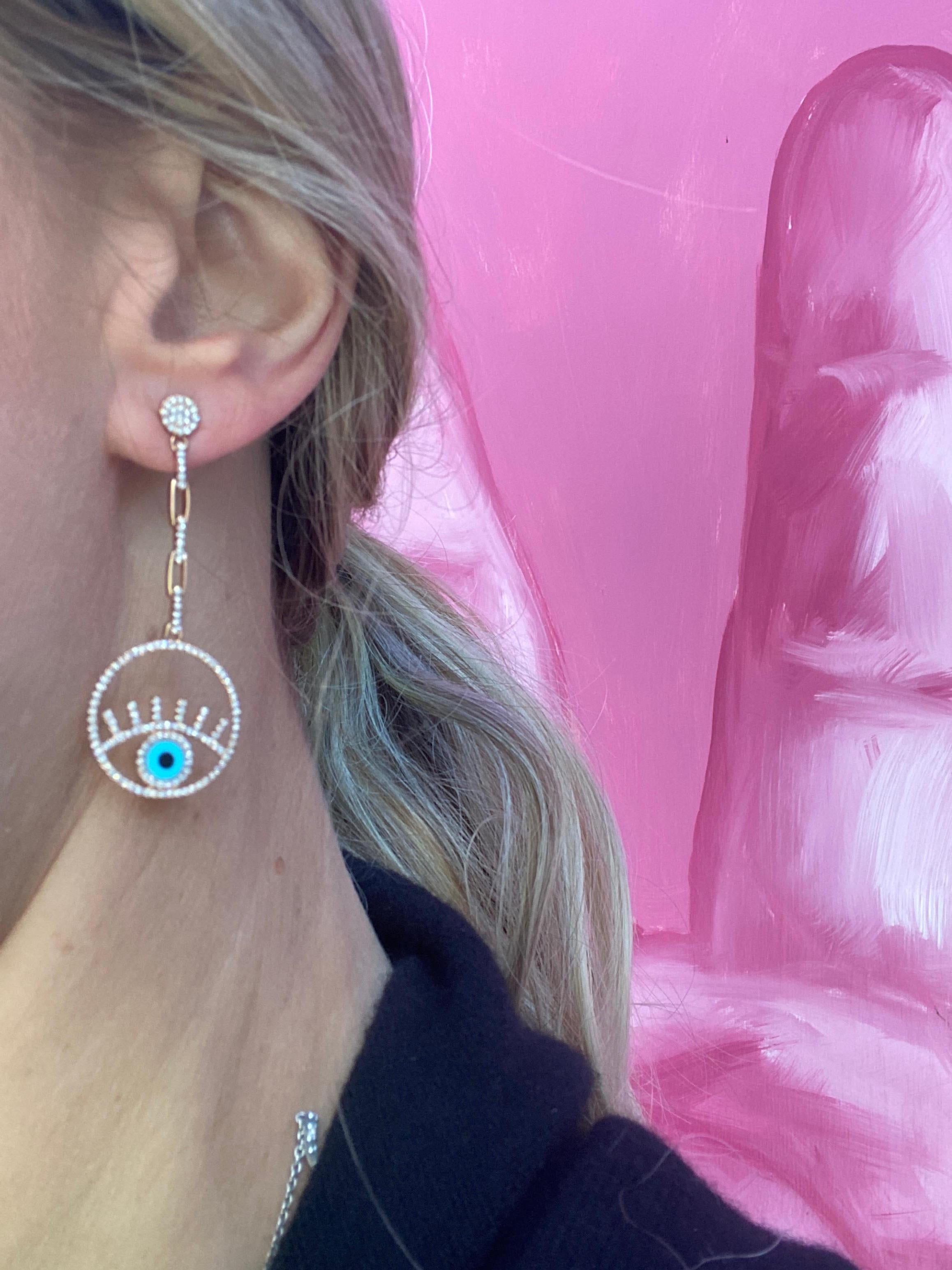 Protect yourself by wearing these 14 karat rose gold evil eye drop earrings featuring 0.89 carat total weight in round diamonds and onyx and turquoise accents as the eye. Butterfly back. These are approximately 2