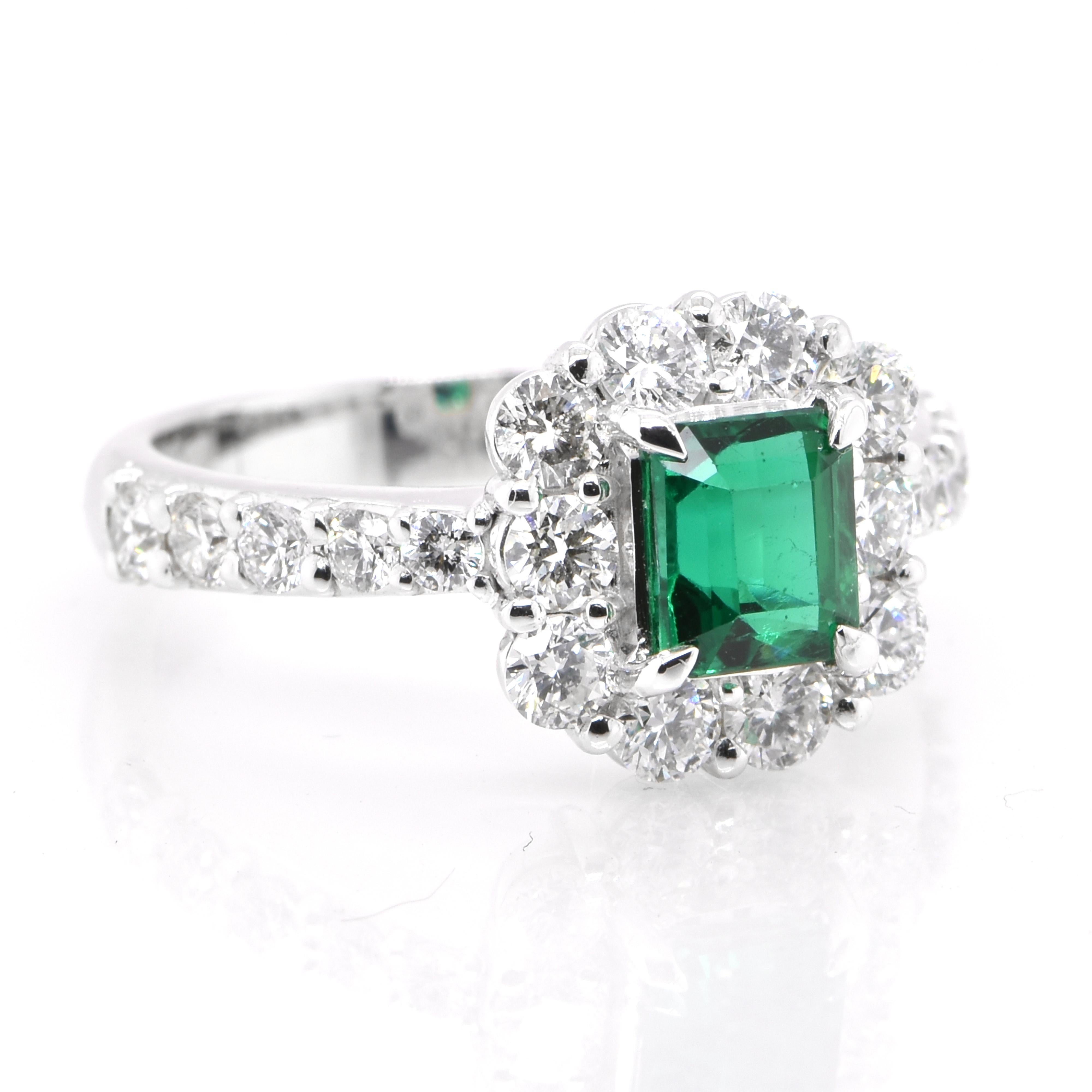 Modern 0.89 Carat Vivid Green Emerald and Diamond Halo Ring Set in Platinum For Sale