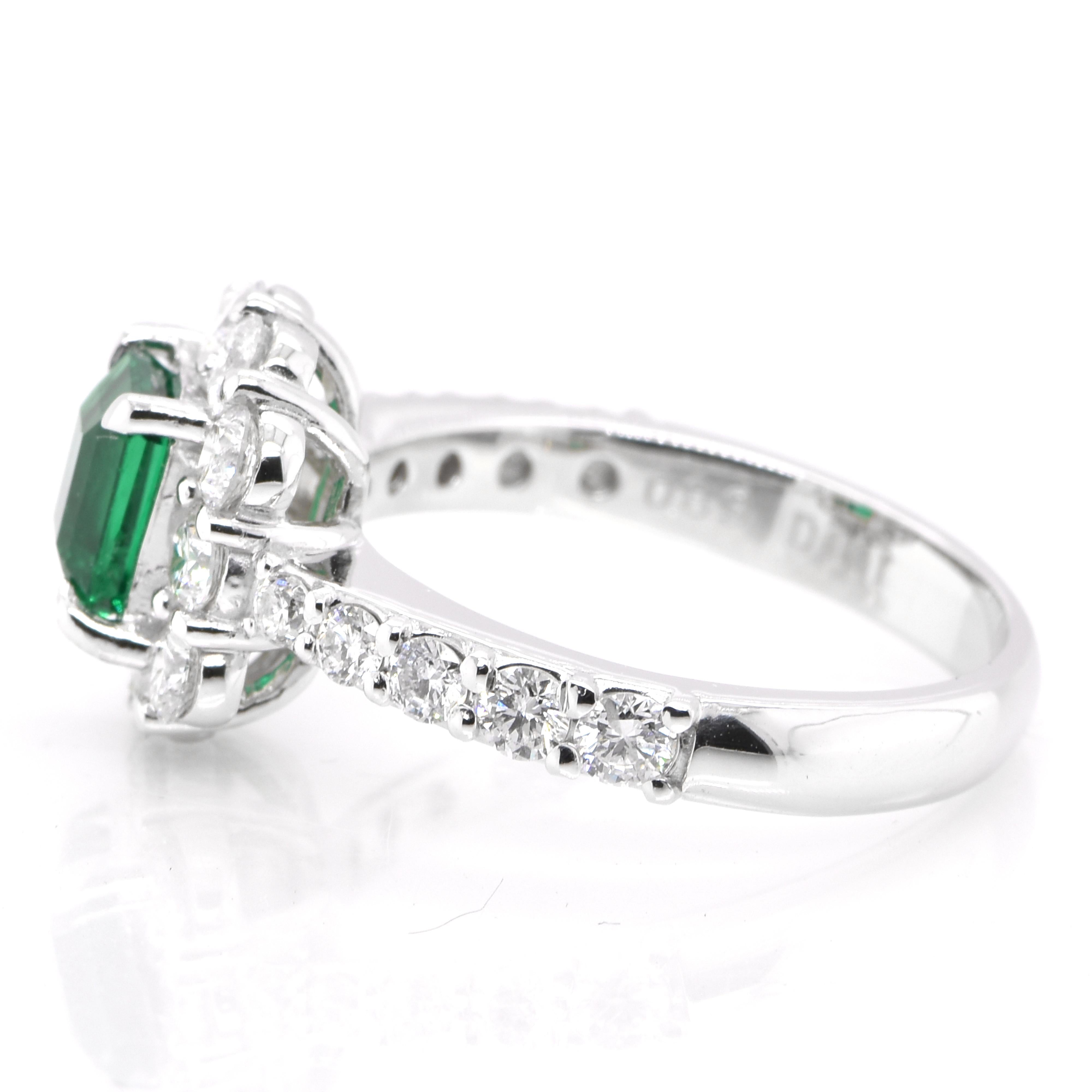 Emerald Cut 0.89 Carat Vivid Green Emerald and Diamond Halo Ring Set in Platinum For Sale