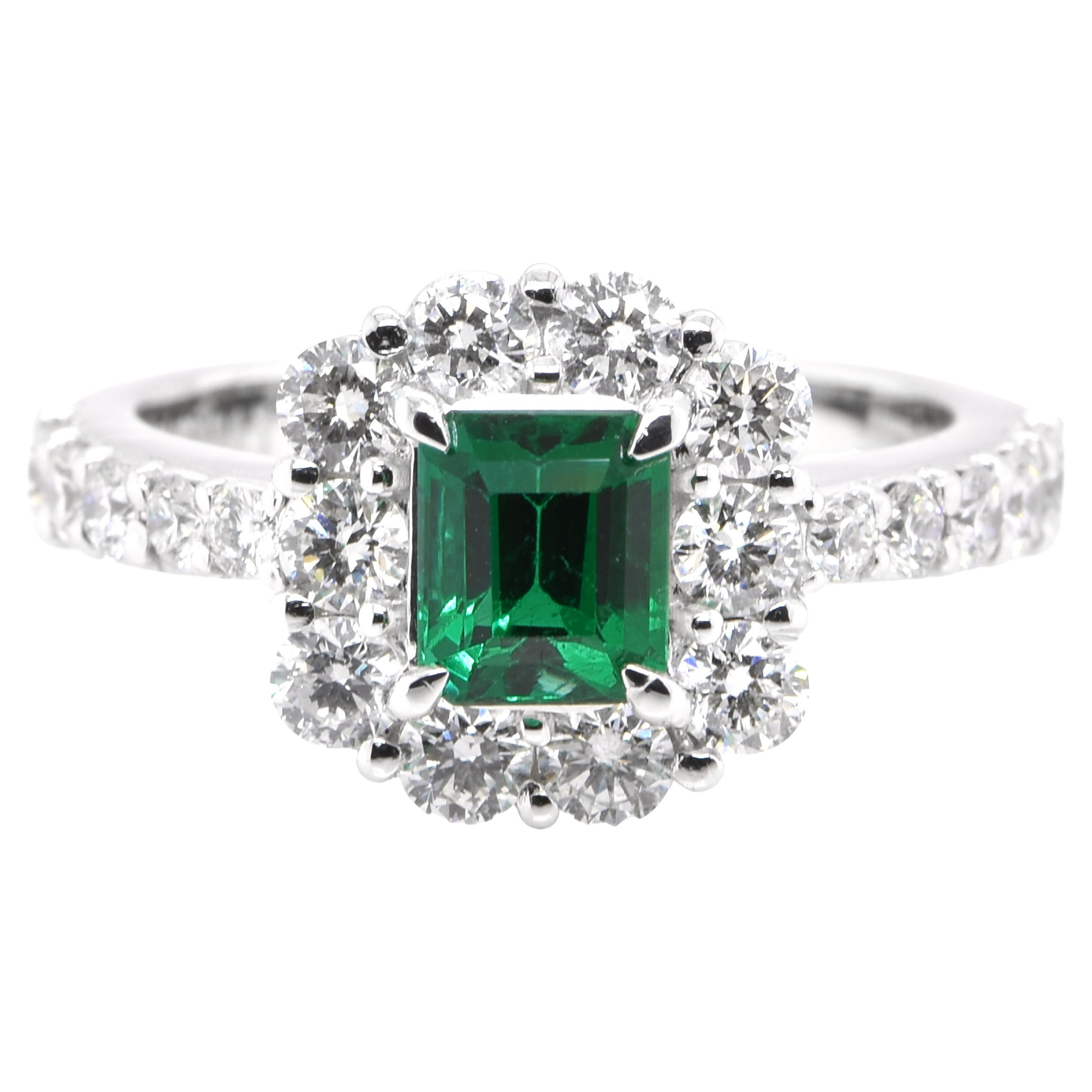 0.89 Carat Vivid Green Emerald and Diamond Halo Ring Set in Platinum For Sale