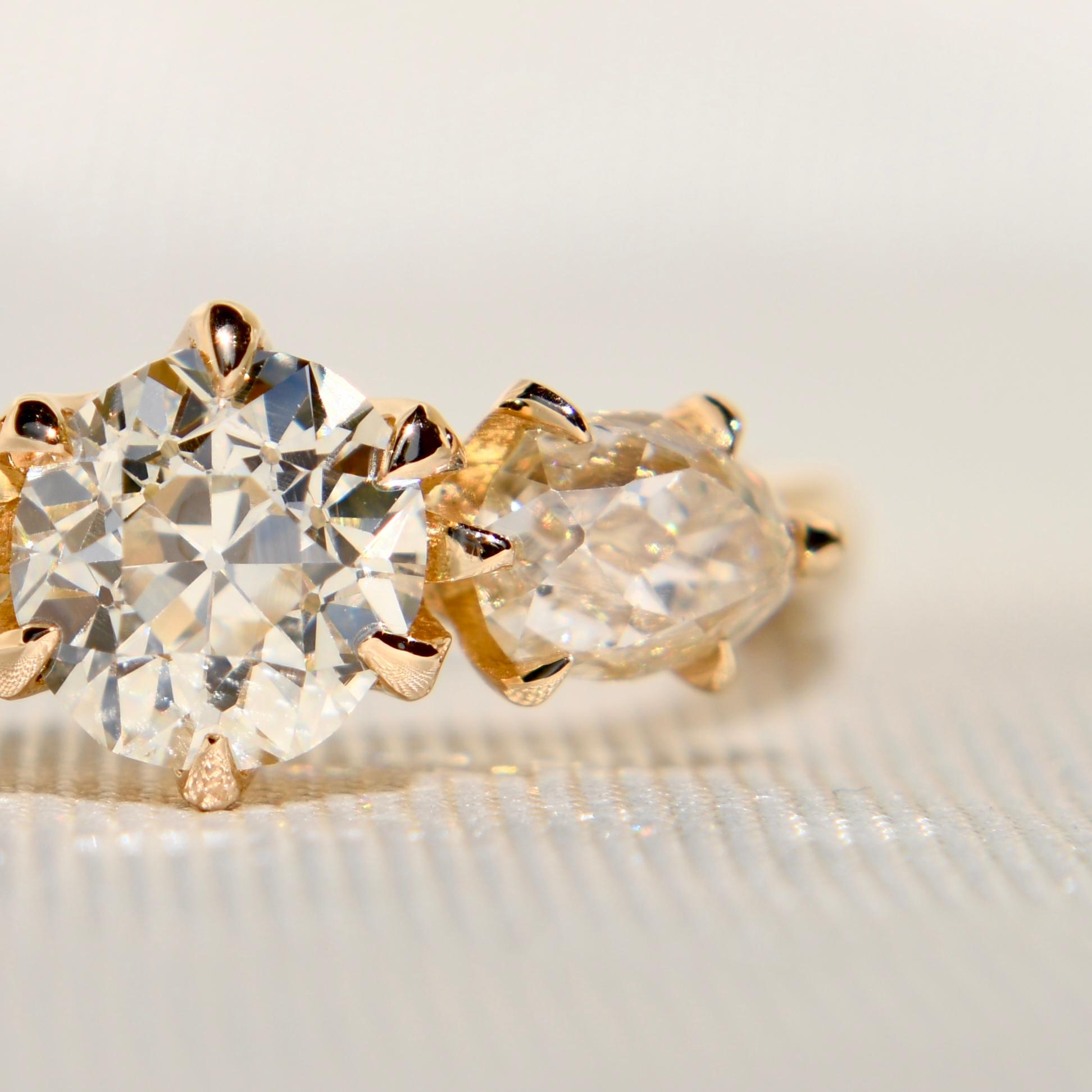 This ring was newly made by Beaubijouxantique.
The diamonds are all antique from the 19th century/ early 20th century.

- One GIA certified old European cut diamond, 0.89 ct (Q to R Range/ VS2) 
- Two old pear cut diamonds, 0.91 ct total (K/ SI1)
-
