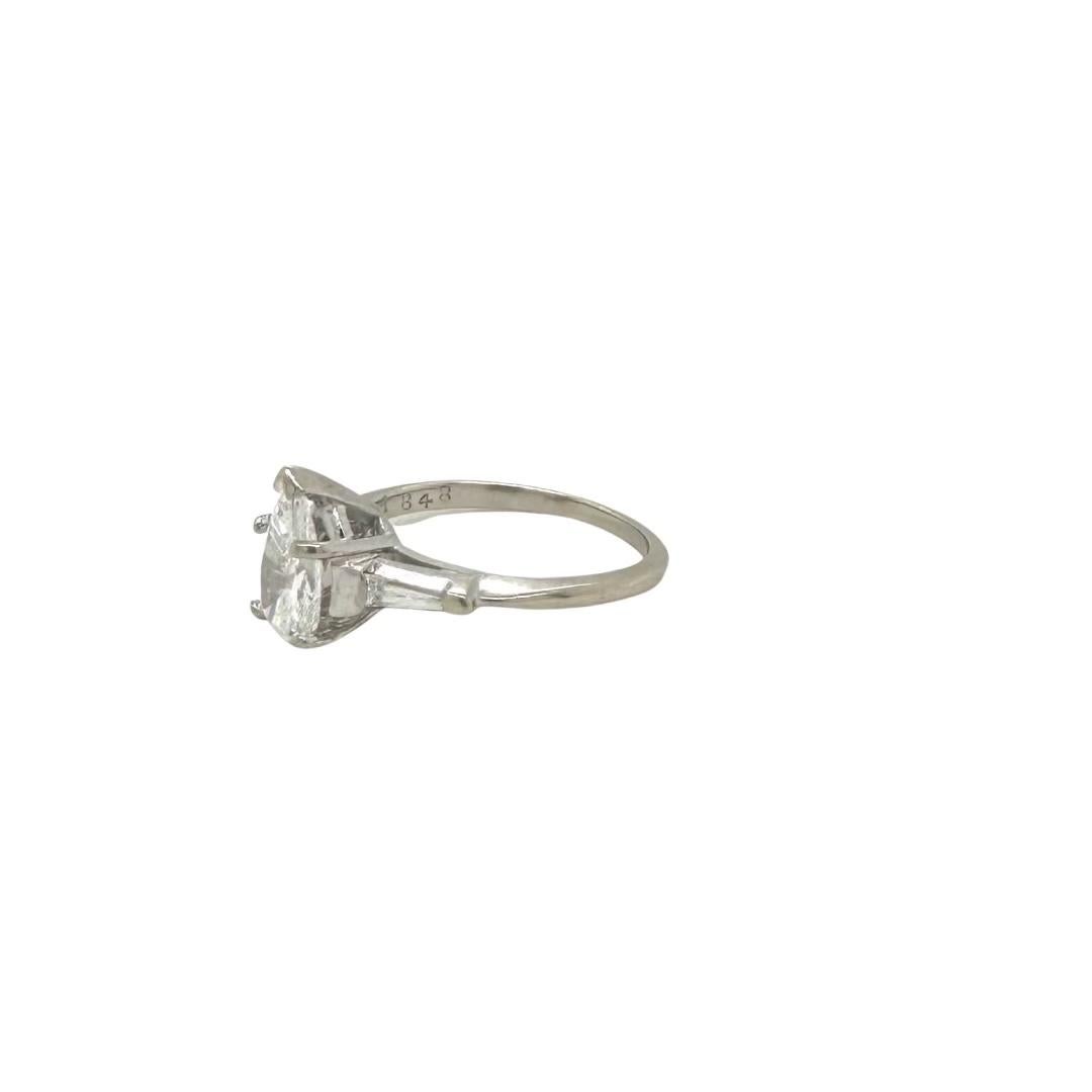 Style: Pear Shaped Diamond Engagement Ring
Metal: White Gold 
Metal Purity: 14K 
​​​​​​​Primary Stone: Diamond
Diamond Color: E
Diamond Clarity: VS1
​​​​​​​Carat Weight: 0.8 ct​​​​​​​
Secondary Stones: 2 Baguette Diamonds
Ring Size: 5