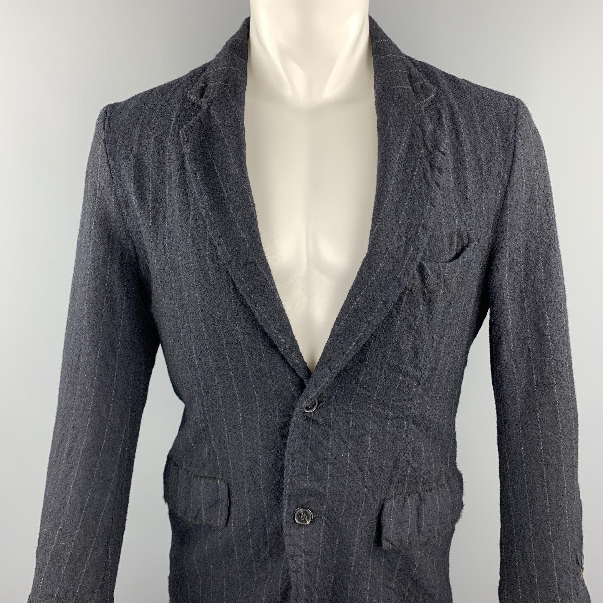 08SIRCUS jacket comes in a navy chalk stripe wool featuring a notch lapel style, flap pockets, and a two button closure. Made in Japan.Very Good
Pre-Owned Condition. 

Marked:   2/48 

Measurements: 
 
Shoulder: 19 inches 
Chest: 42 inches 
Sleeve:
