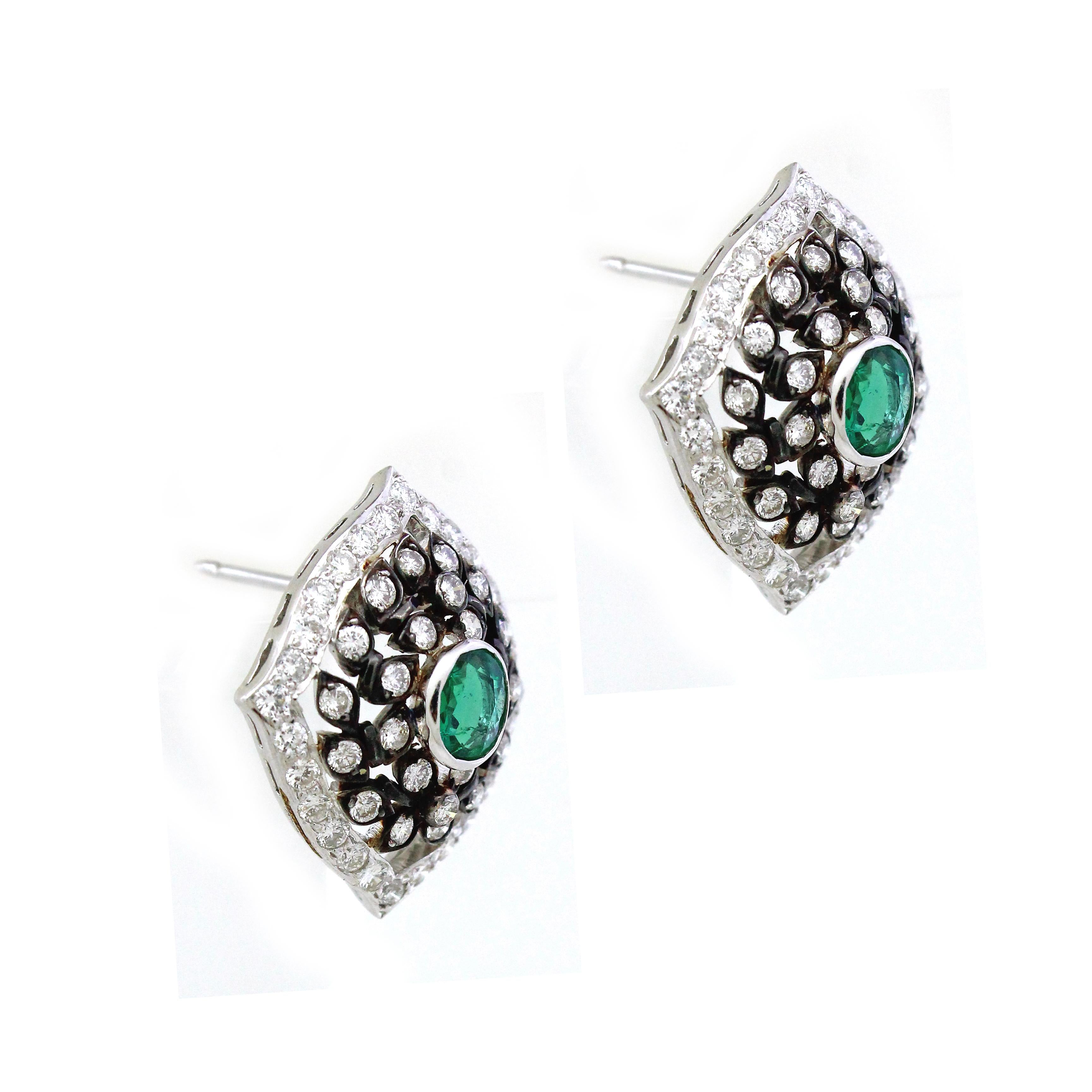 Indulge in the celestial allure of our exquisite pair of earrings, crafted with utmost precision in radiant 18k white gold. Inspired by the enchanting wonders of nature, each earring features two resplendent oval-shaped Emeralds, totaling 0.89