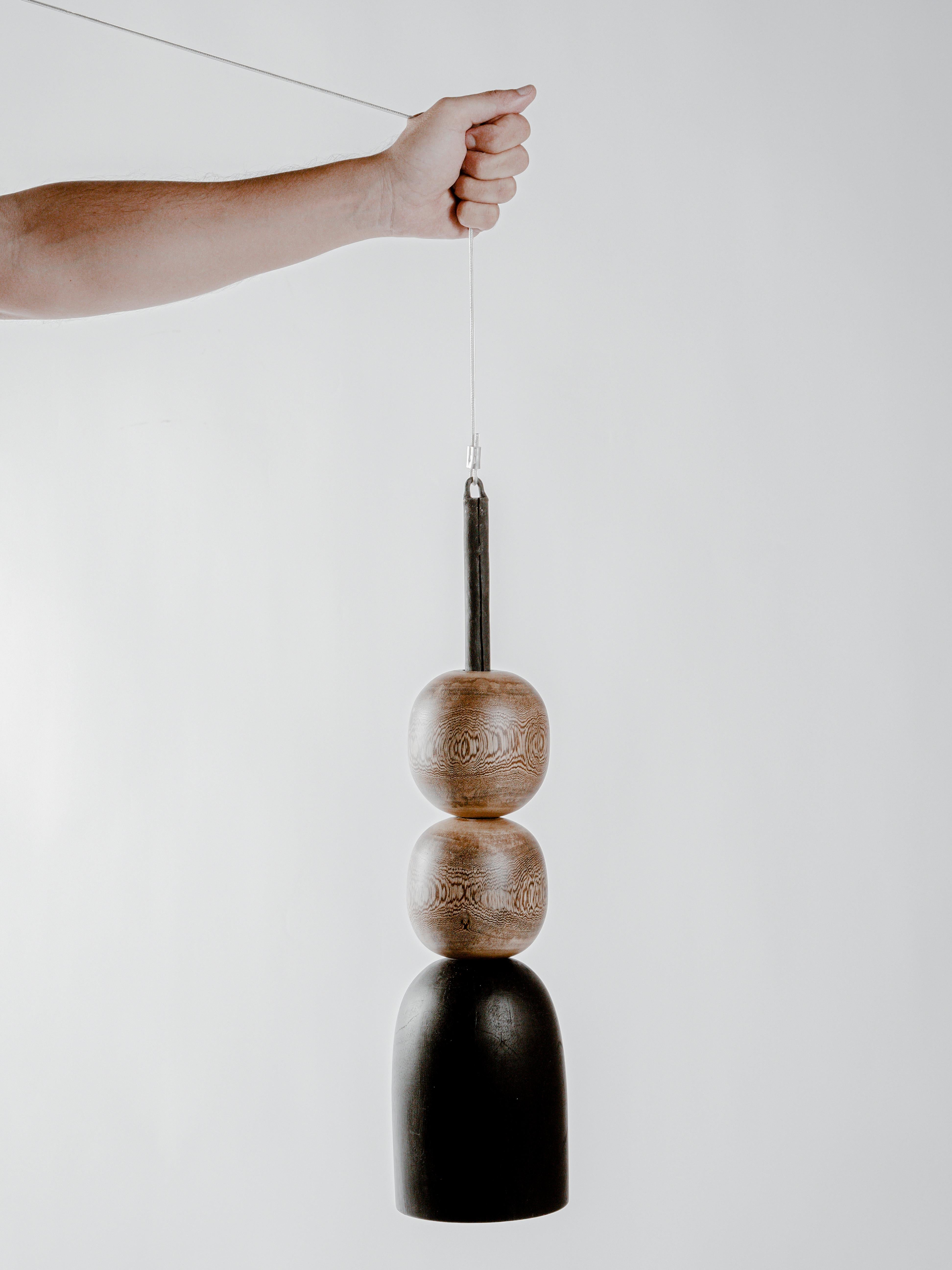 09 Lamp by Daniel Orozco
Dimensions: D 13 x H 40 cm.
Materials: Wood

Black wood -based pendant lamp and 2 natural jabin wood balls. Handmade by Mexican artisans.

All our lamps can be wired according to each country. If sold to the USA it will be