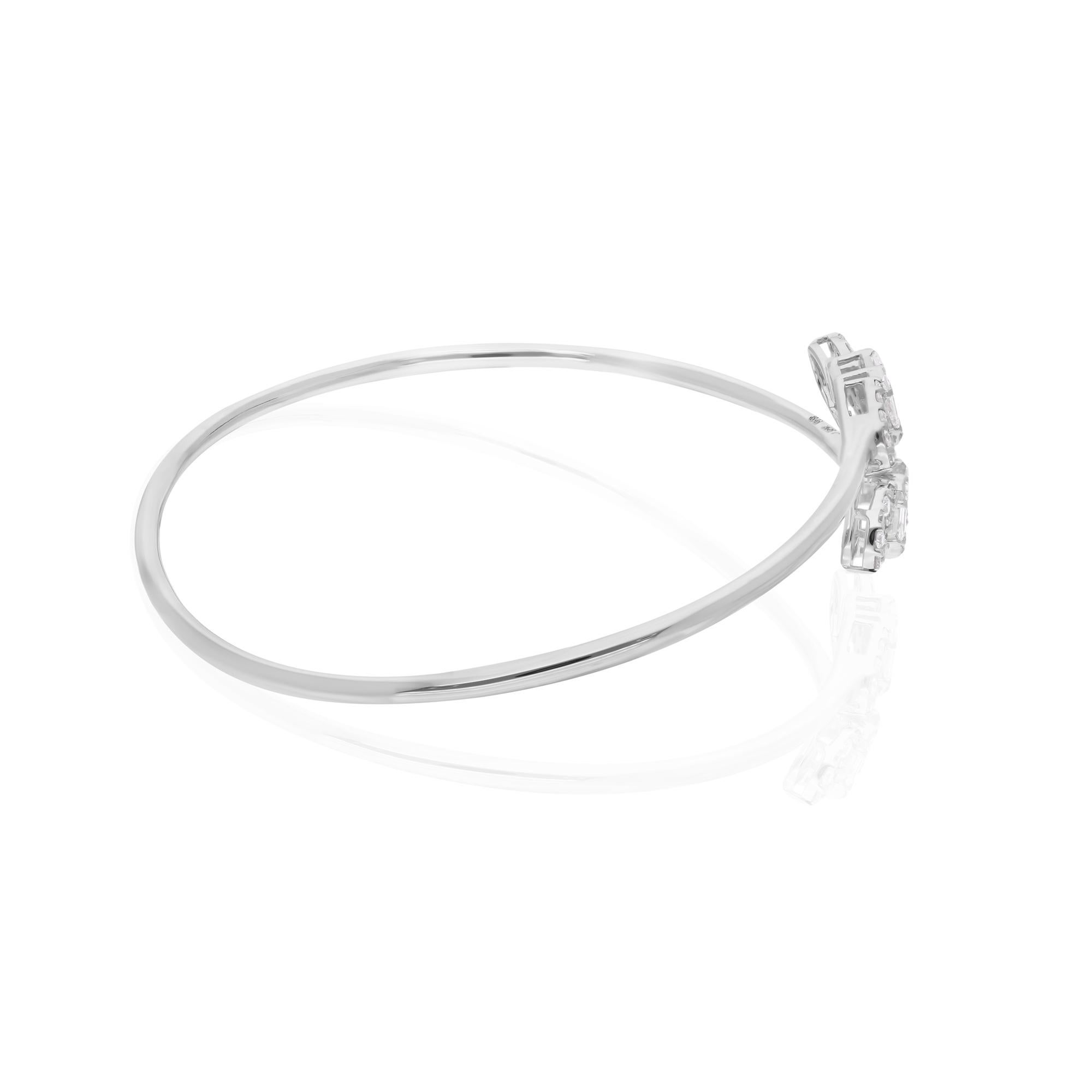 Indulge in the timeless elegance of this exquisite 0.90 Carat Baguette Round Diamond Bangle Bracelet, crafted with meticulous attention to detail in 14 Karat White Gold. This stunning piece of jewelry exudes sophistication and luxury, making it a