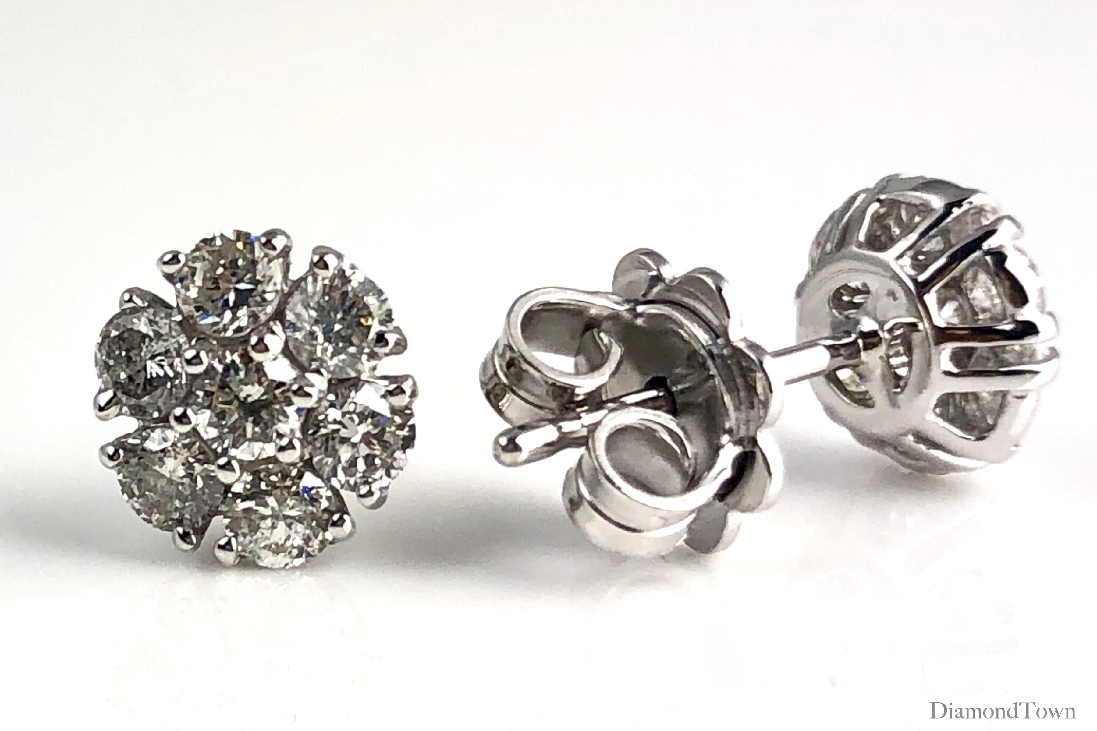 These stud earrings feature 14 round white diamonds (seven diamonds per earring) arranged in a cluster flower shape. A suitable bridal accompaniment, or for the event of your choice.

Set in 14k White Gold.

Many of our items have matching companion