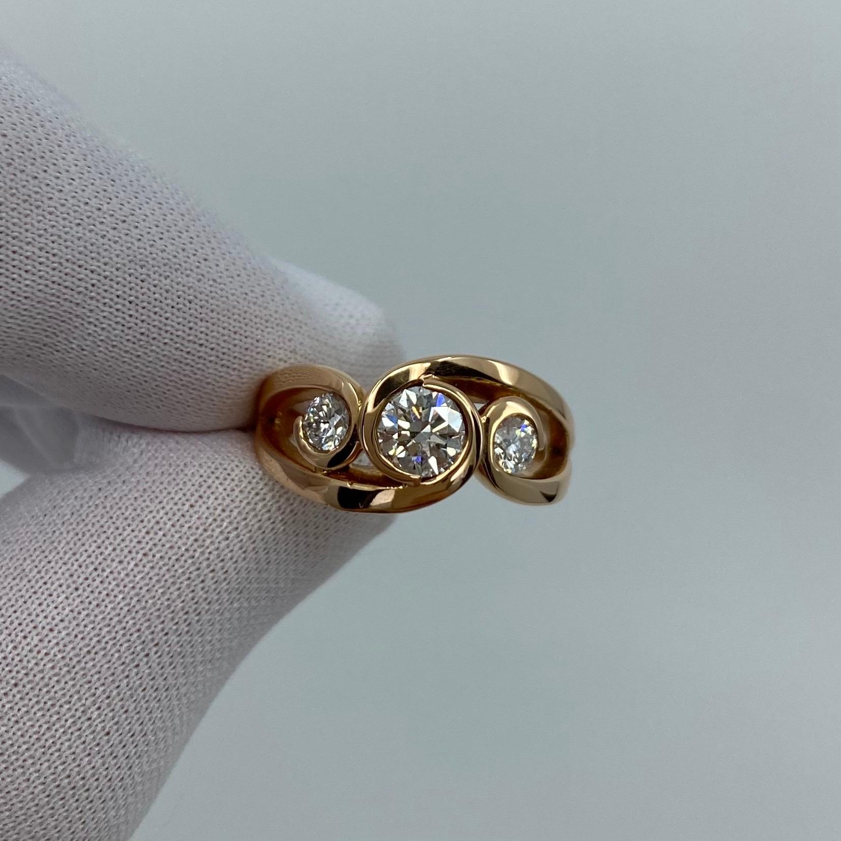 18k Rose Gold Diamond Three Stone Ring

A stunning 18 Karat rose gold diamond ring with 3 beautiful white diamonds in a unique swirl scroll style. 
The diamonds are approx Si1-Si2 Clarity and G/H Colour. Centre stone is 0.50ct with the two side