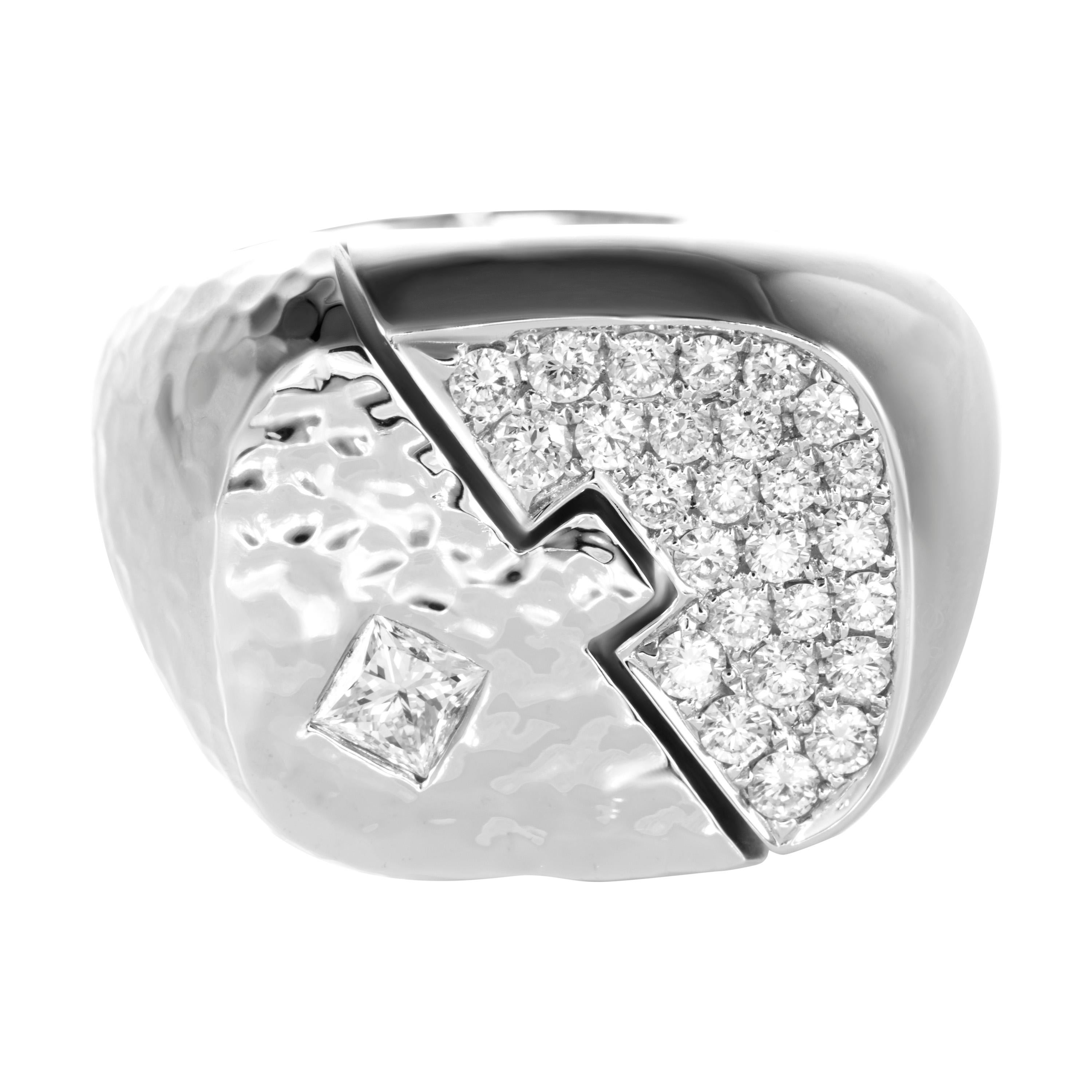 Cast from 18 karat white gold into two intertwining plates, Butani's ring is adorned with 0.60 carats of white diamonds on one side and on hammered 18K gold surrounds a 0.30 carat princess cut diamond on the other side, creating a yin-yang design. 