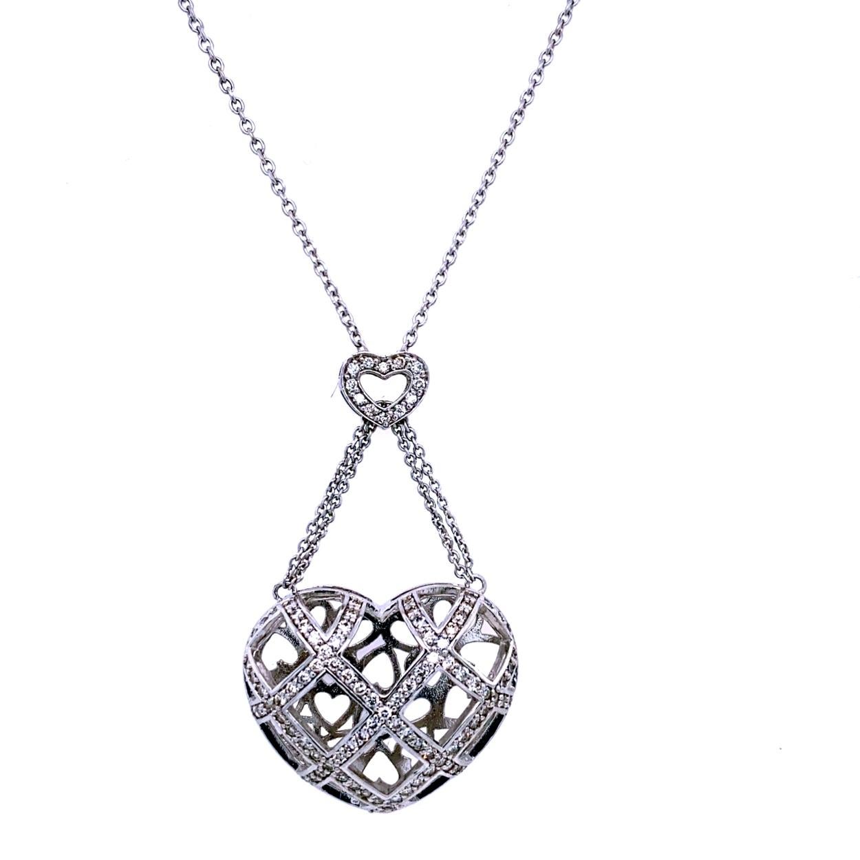 14K Gold Pave Set Puffed Heart Shape Pendant dangling from another heart shape pendant. 99 pieces of Round Brilliant diamonds with total Diamond Weight of 0.90 Ct. Look at the beautiful Heart Shape Gallery on the back.
Total Diamond Weight: 0.90