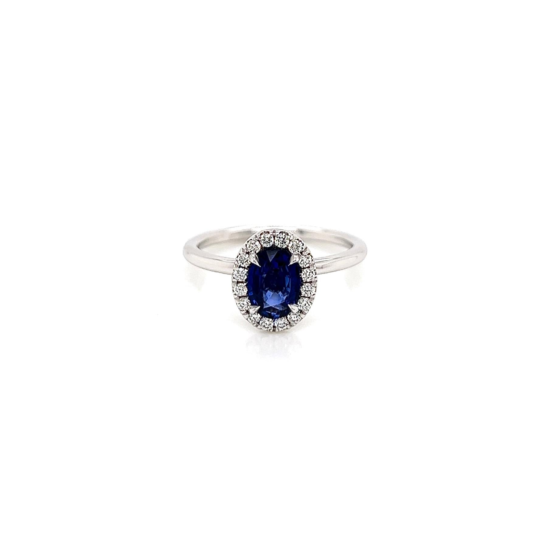 1.14 Total Carat Sapphire Diamond Ladies Halo Ring

-Metal Type: 18K White Gold
-0.90 Carat Oval Cut Blue Sapphire
-0.24 Carat Round Side Diamonds 
-Size 6.0

Made in New York City.