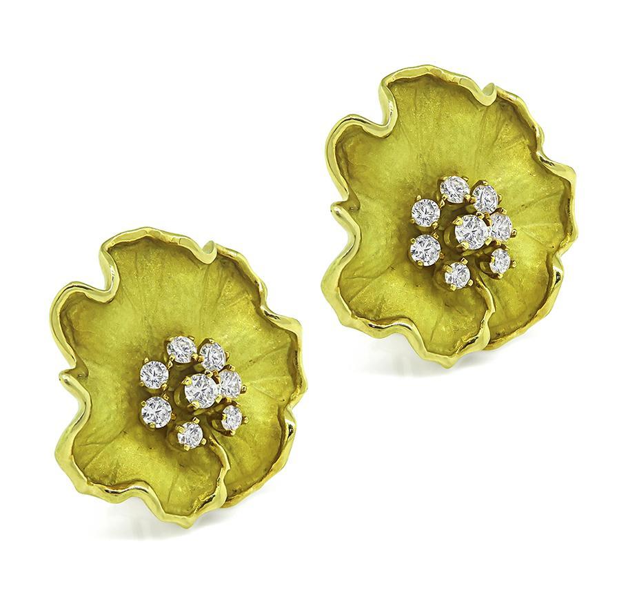 This is a fabulous pair of 18k yellow gold flower earrings. The earrings feature sparkling round cut diamonds that weigh approximately 0.90ct. The color of these diamonds is G with VS clarity. The earrings measure 25mm by 25mm and weigh 21.7 grams.