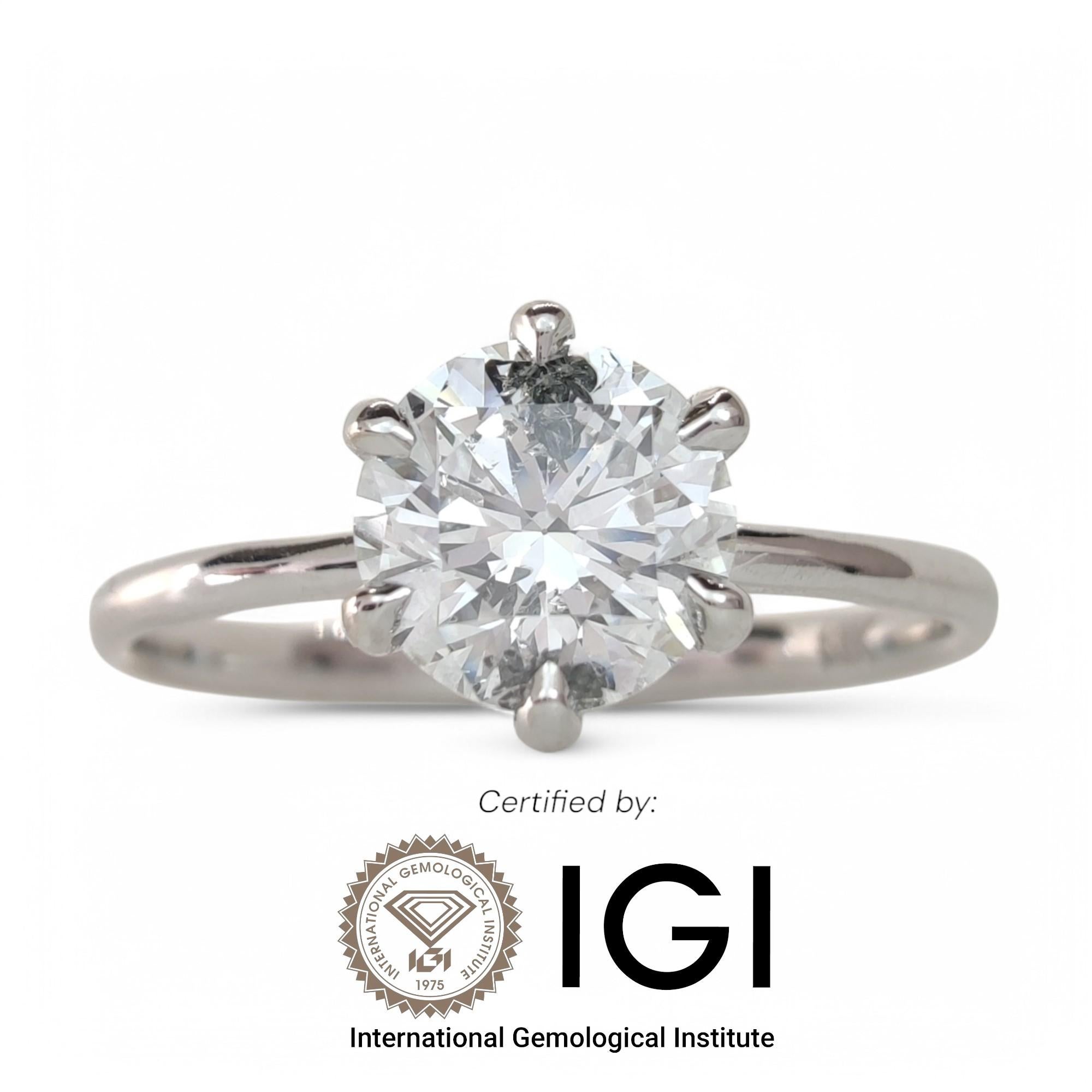 This stunning 18K white gold solitaire engagement ring is a timeless symbol of elegance and commitment. Expertly handcrafted, it features a breathtaking 0.90-carat natural round brilliant diamond (6.15mm / 0.242 inches), exhibiting E-F color (near