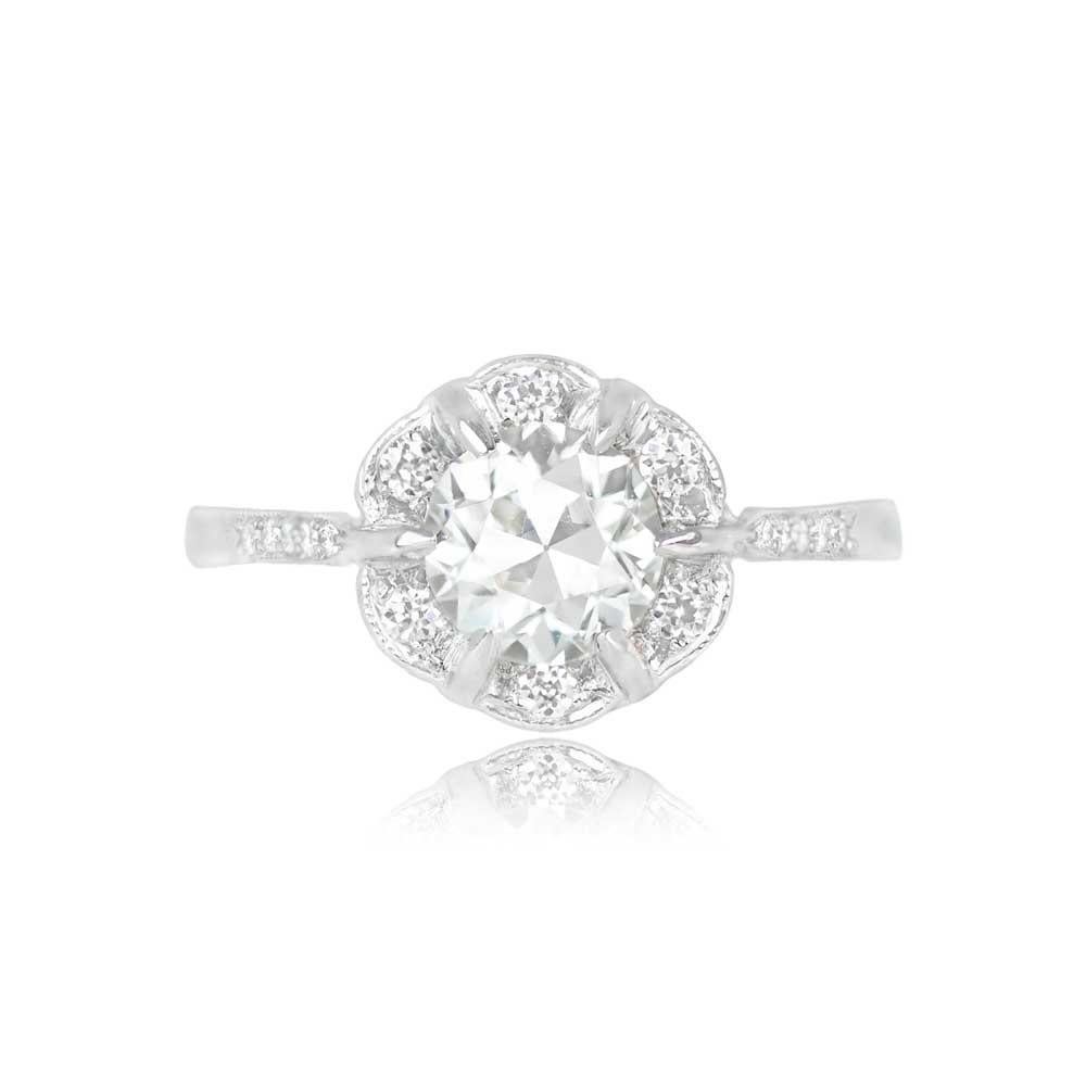 An exquisite Art Deco-style platinum ring showcasing a lively 0.90-carat old European cut diamond in a prong setting. A cluster of old European cut diamonds surrounds the center stone, while more diamonds are pave-set along the shoulders. The center