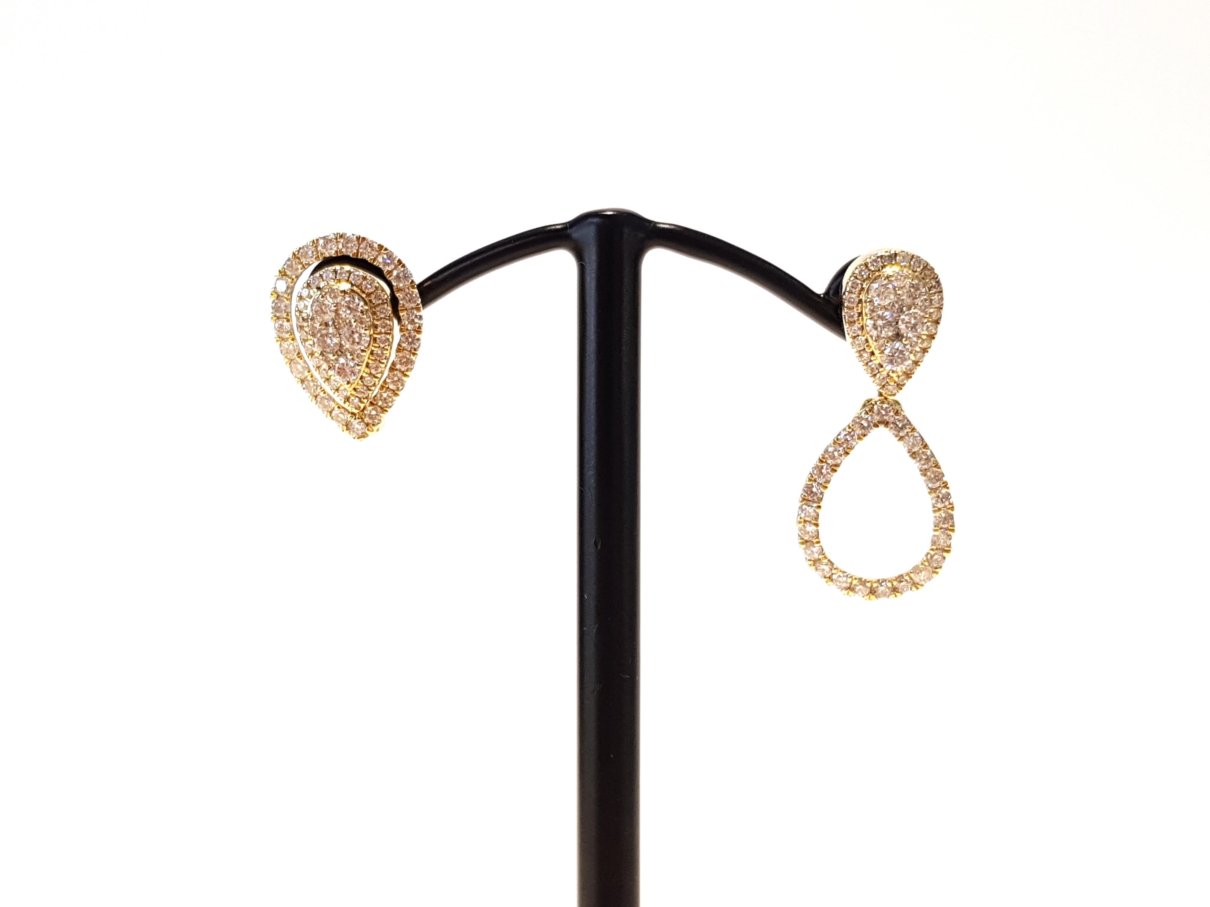 A striking set of interchangeable pear shaped earrings beautifully set in 18K yellow gold. 0.90ct of round brilliant diamonds illuminate these precious earrings that change from studs to drop earrings.  The weight of these earrings are 3.7g. These