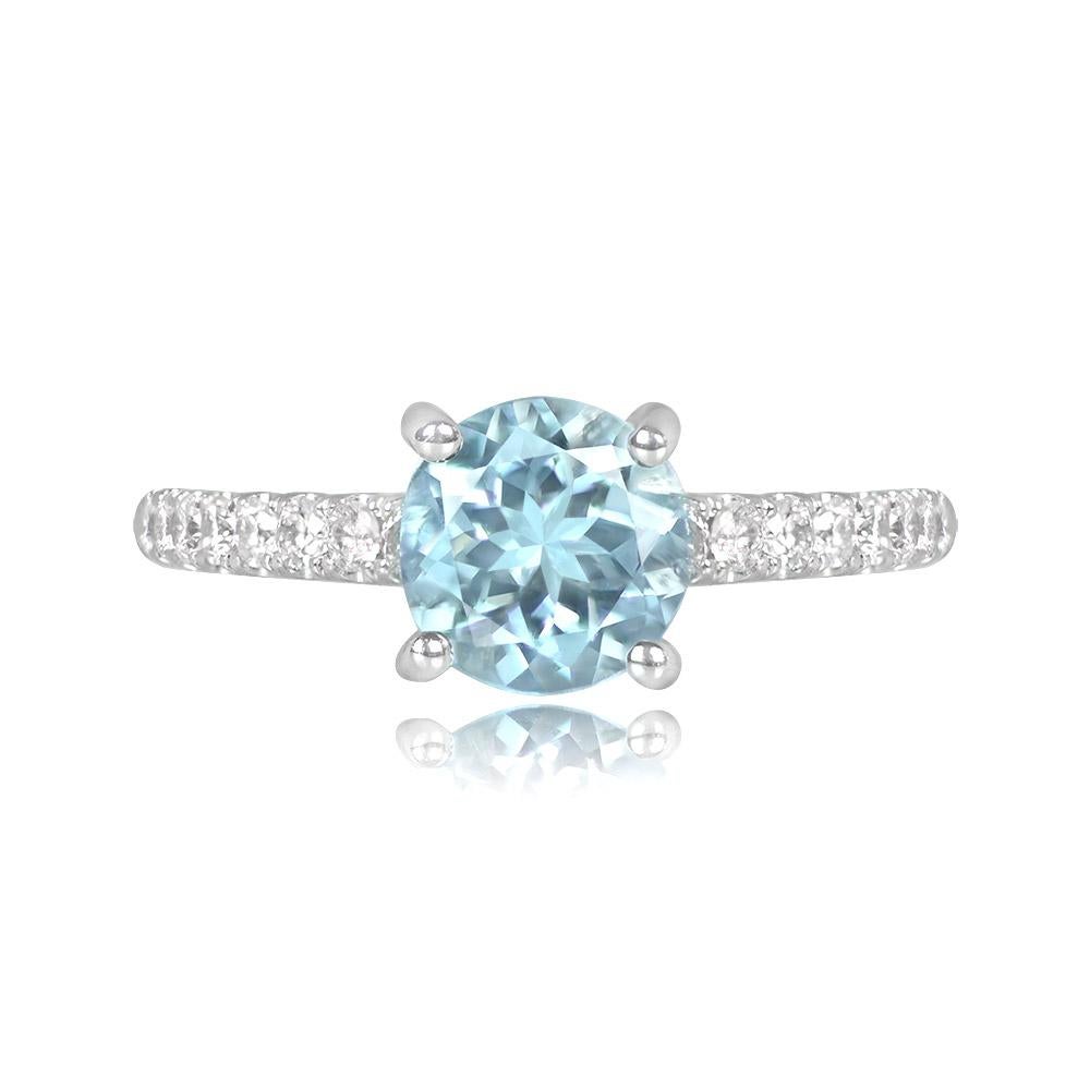 A stunning aquamarine and diamond ring showcasing a 0.90-carat round-cut aquamarine set in prongs, with round brilliant-cut diamonds adorning the shoulders. The total diamond weight is about 0.30 carats. Handcrafted in 18k white gold.


Ring Size: