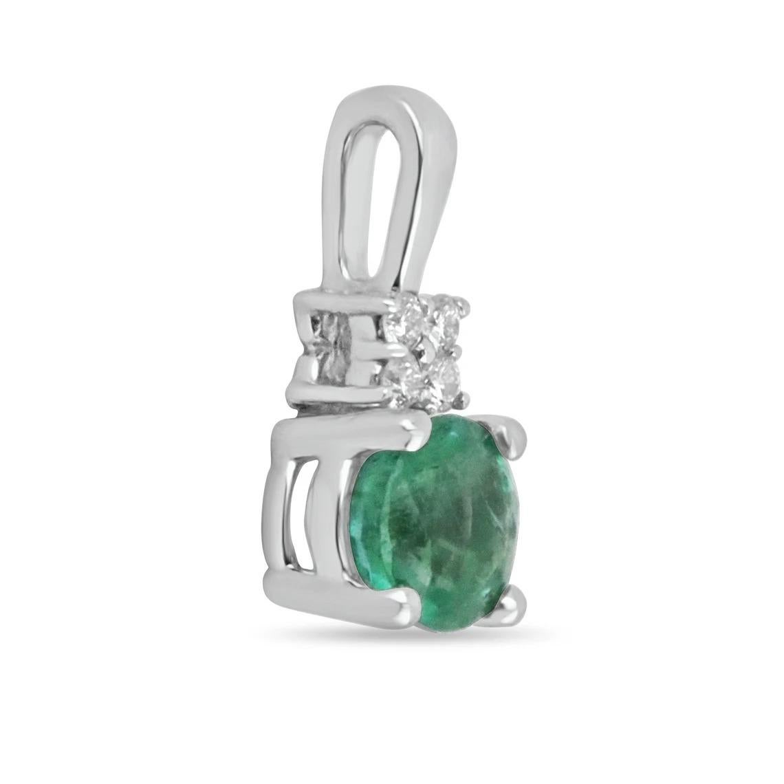 Featured here is a stunning, round natural emerald & diamond necklace in fine 14K white gold. Displayed is a medium-green emerald with very good transparency, accented by a simple four-prong mount allowing for the emerald to be shown in full view.