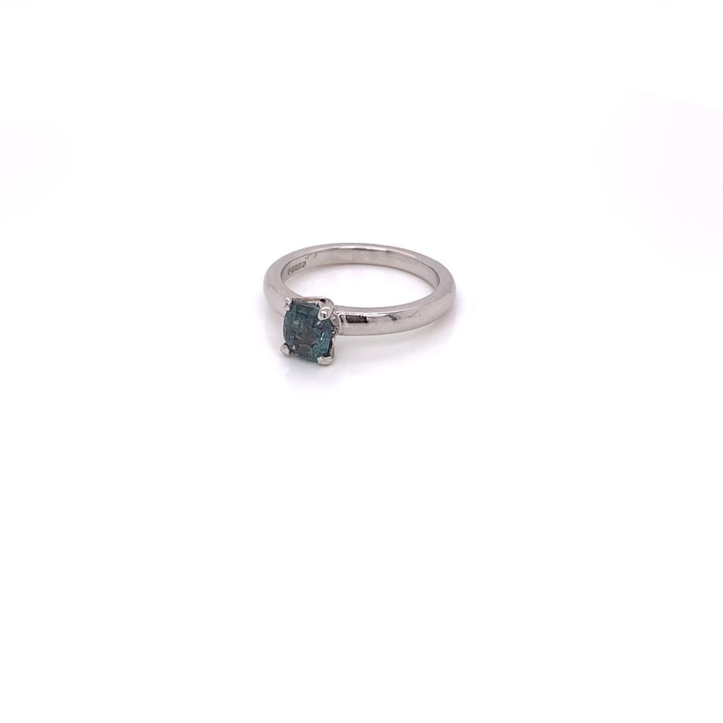 This Elegant Ring consists of a Cushion Cut Alexandrite, a fascinating stone which in daylight glows deep Green with a Brown hue that can turn red in incandescent light, showcasing this gem's unique ability to change colour. The exquisite gem at the