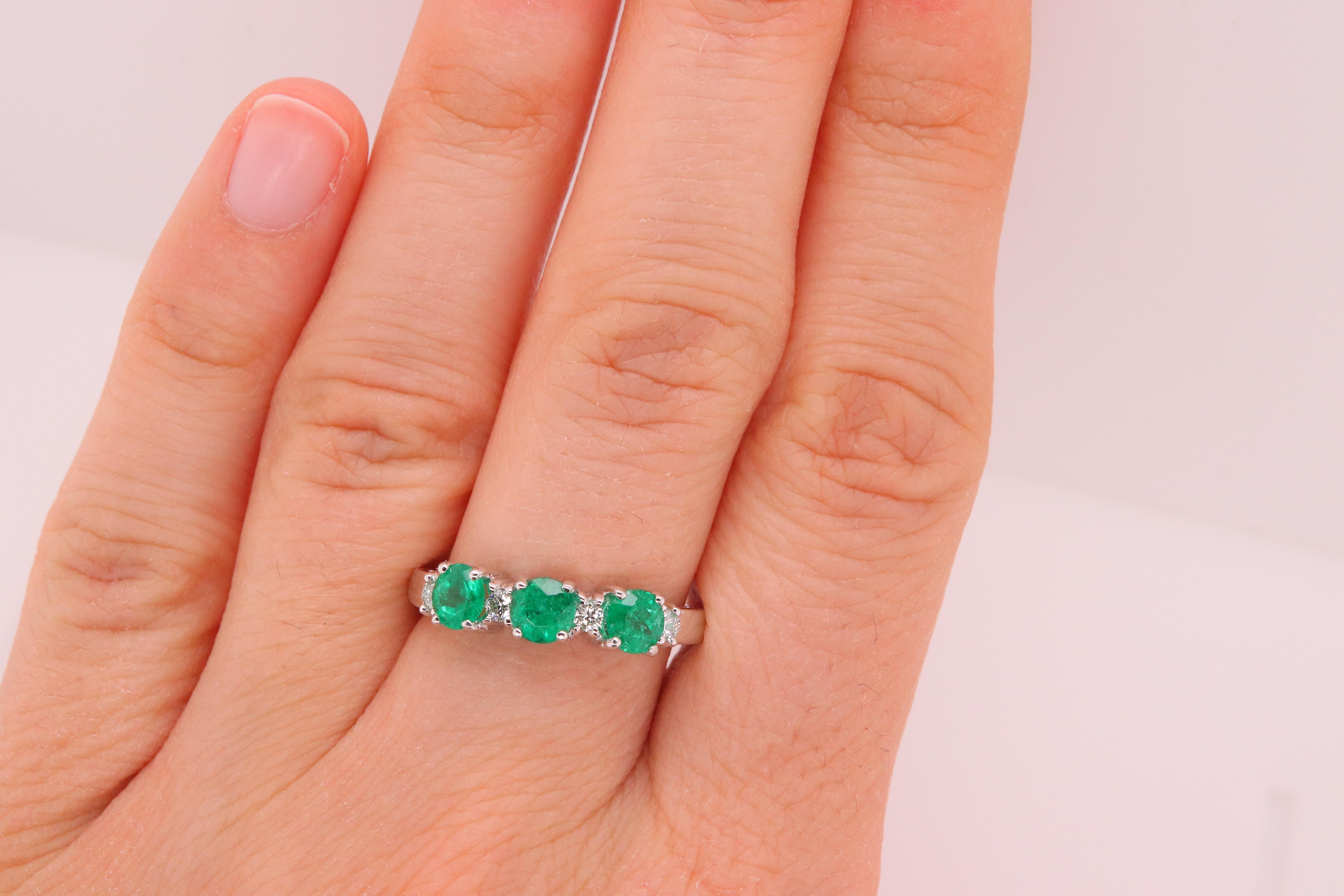 Material: 14k White Gold 
Stone Details: 3 Round Emeralds at 0.91 Carats - Measuring 4 mm
Diamond Details: 4 Brilliant Round Diamonds at 0.14 Carats - Clarity: SI / Color: H-I
Ring Size: 7. Alberto offers complimentary sizing on all rings.

Fine
