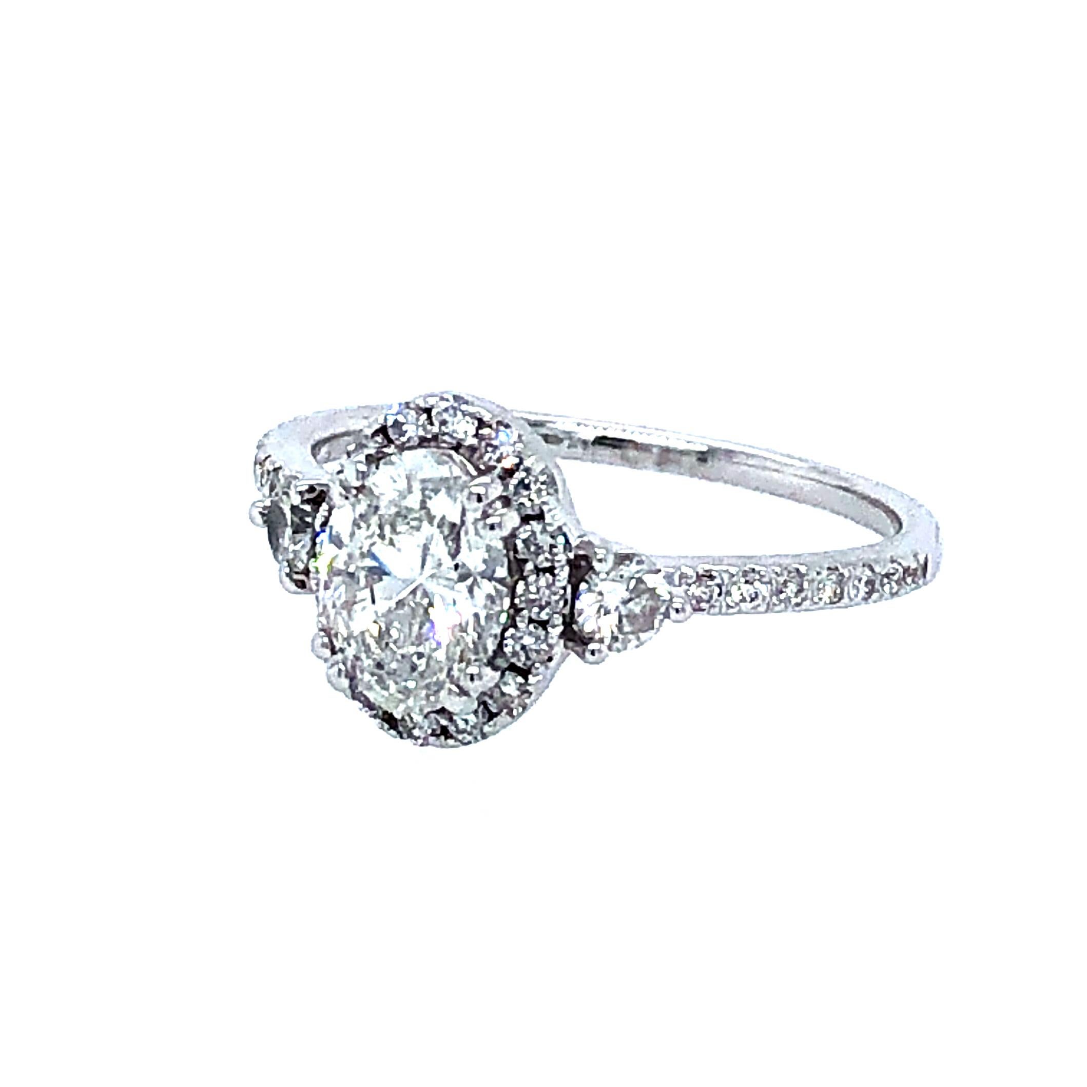 Offered here is a classic oval shape diamond engagement ring set in 14kt white gold. The center diamond is GIA certified 0.91 carat G color Si2 clarity, excellent, very good and no fluorescent. The ring has H color Vs2 clarity round brilliant cut