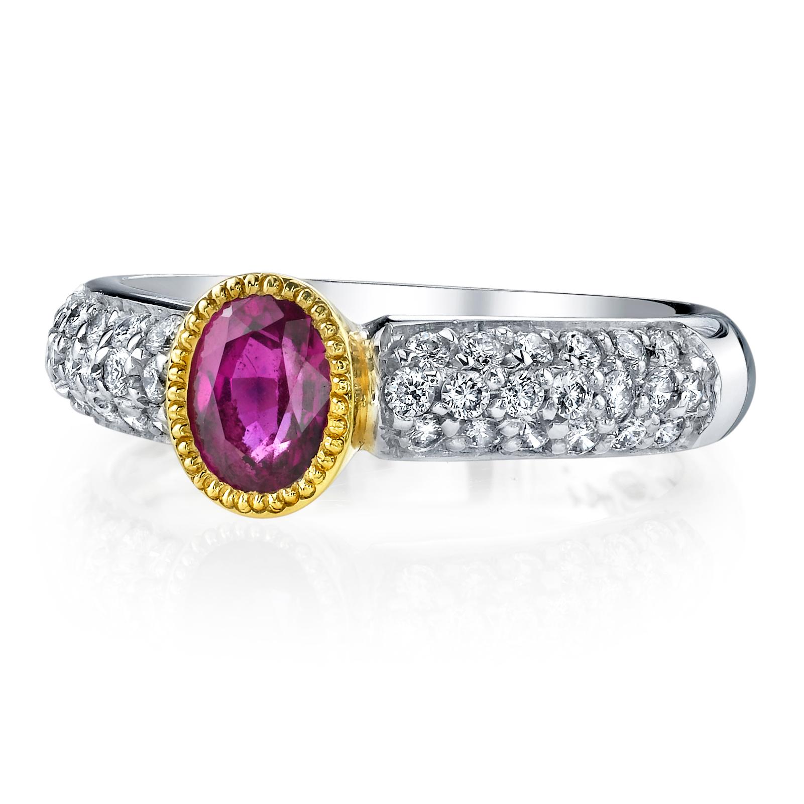 This eye-catching Burmese ruby and diamond ring features a vibrant .91 carat bright pinkish ruby set in a rich 18k yellow gold bezel that has been embellished with beautiful detail. The white gold band has been 