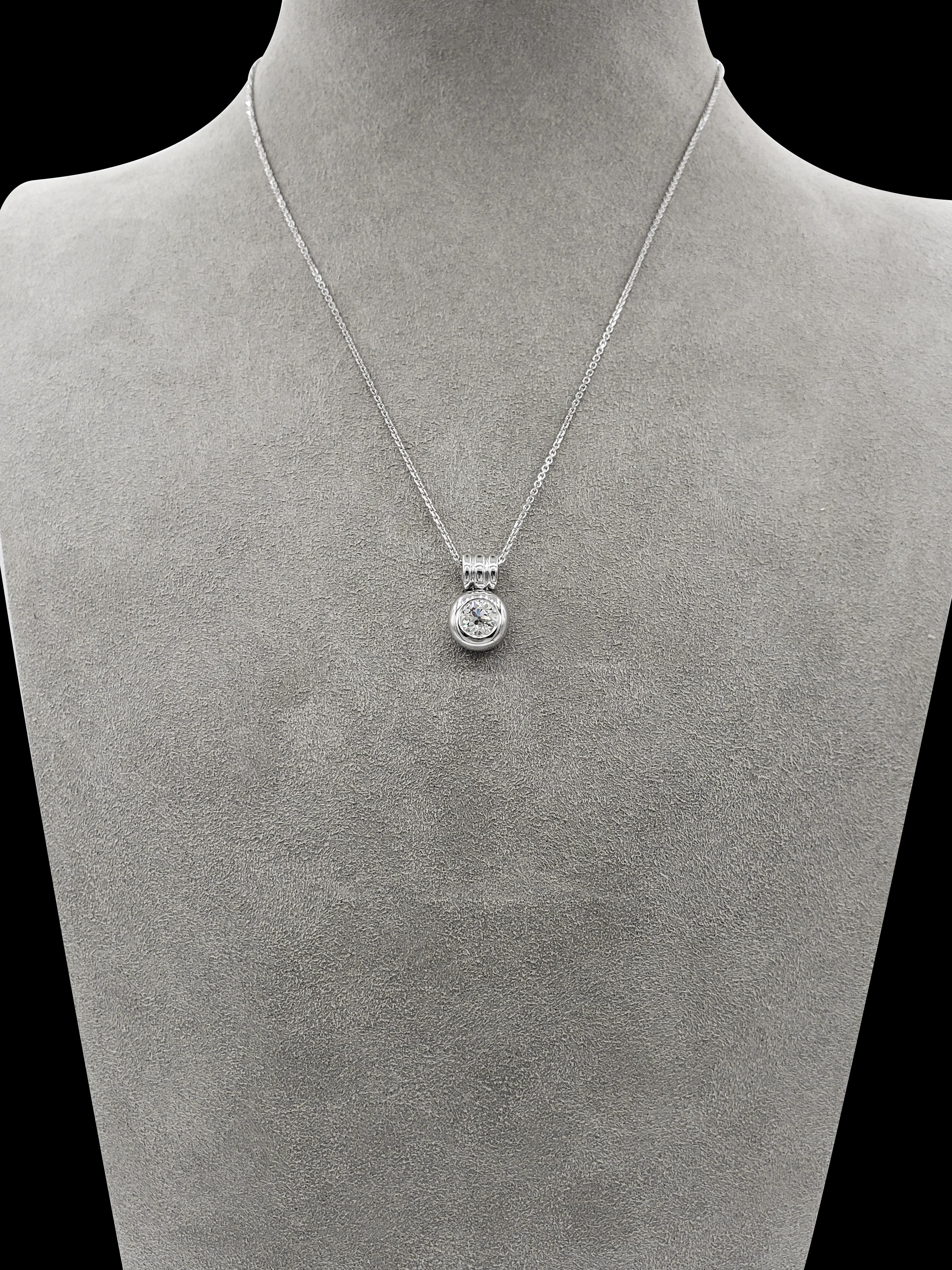 Pendant necklace showcasing a 0.91 carat diamond, set in a heavy bezel setting made in 18 karat white gold. Attached to a three-line bale suspended on a 16 inch white gold chain (sizable upon request).

Style available in different price ranges.