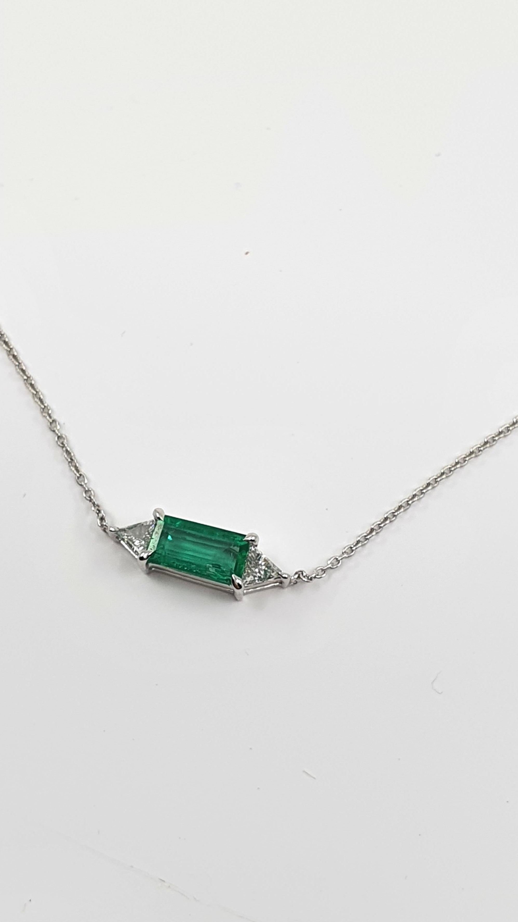 This necklace is where the iconic Art Deco meets contemporary jewelry. This elegant 18 K white gold chain necklace features a gorgeous rectangular clear bright emerald. The Art Deco elements of the jewelry are depicted in the symmetric accurate