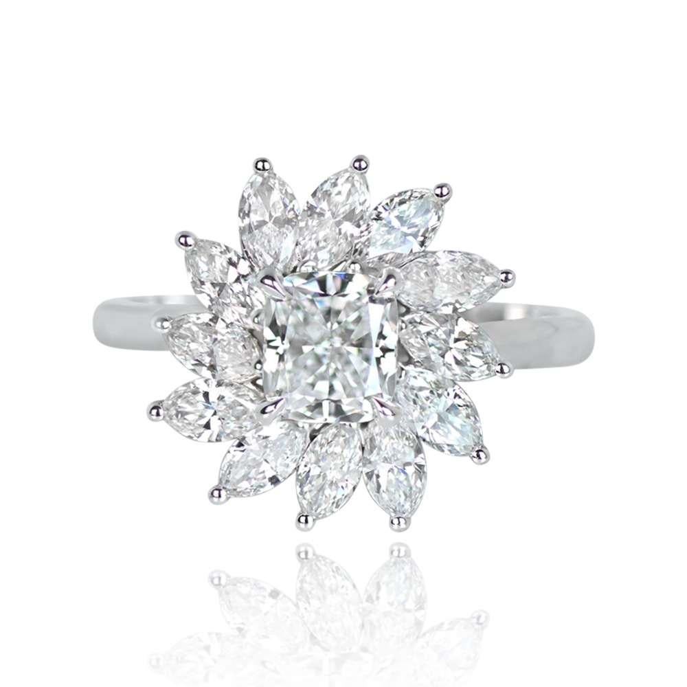 Exquisite 18k white gold engagement ring with a stunning 0.91ct cushion-cut diamond (D color, SI1 clarity). Adorned with a floral cluster halo of marquis cut diamonds (E-F color, VS1-VS2 clarity) totaling approximately 1.14 carats. The unique
