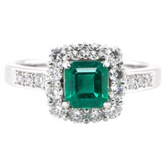 0.92 Carat Natural Vivid Green Emerald and Diamond Halo Ring Set in Platinum