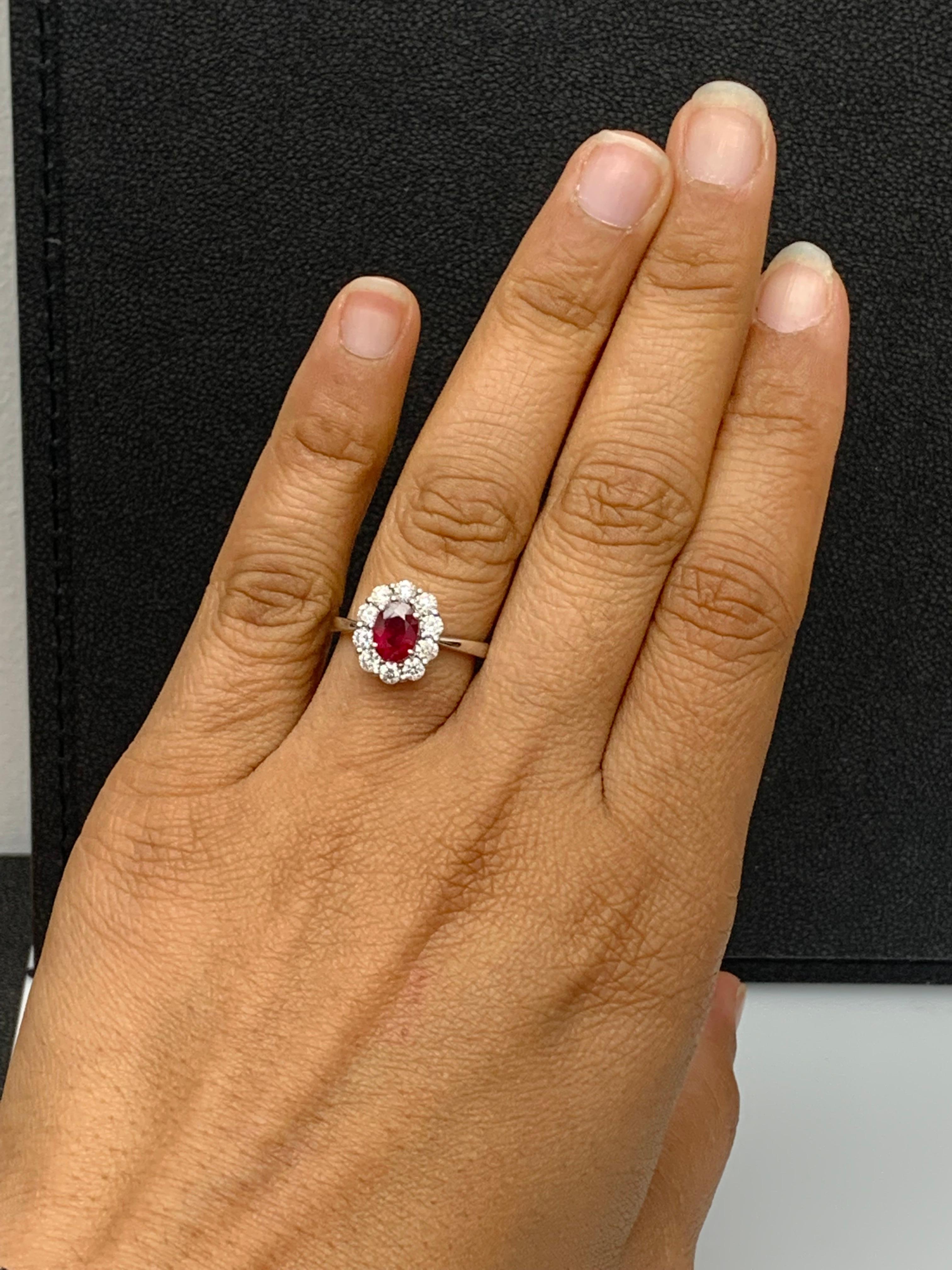 A stunning well-crafted engagement ring showcasing a 0.92-carat oval cut Ruby. Flanking the center diamond are perfectly matched brilliant cut 10 diamonds weighing 0.74 carats in total, set in a polished 18K White Gold mounting. Handcrafted in our