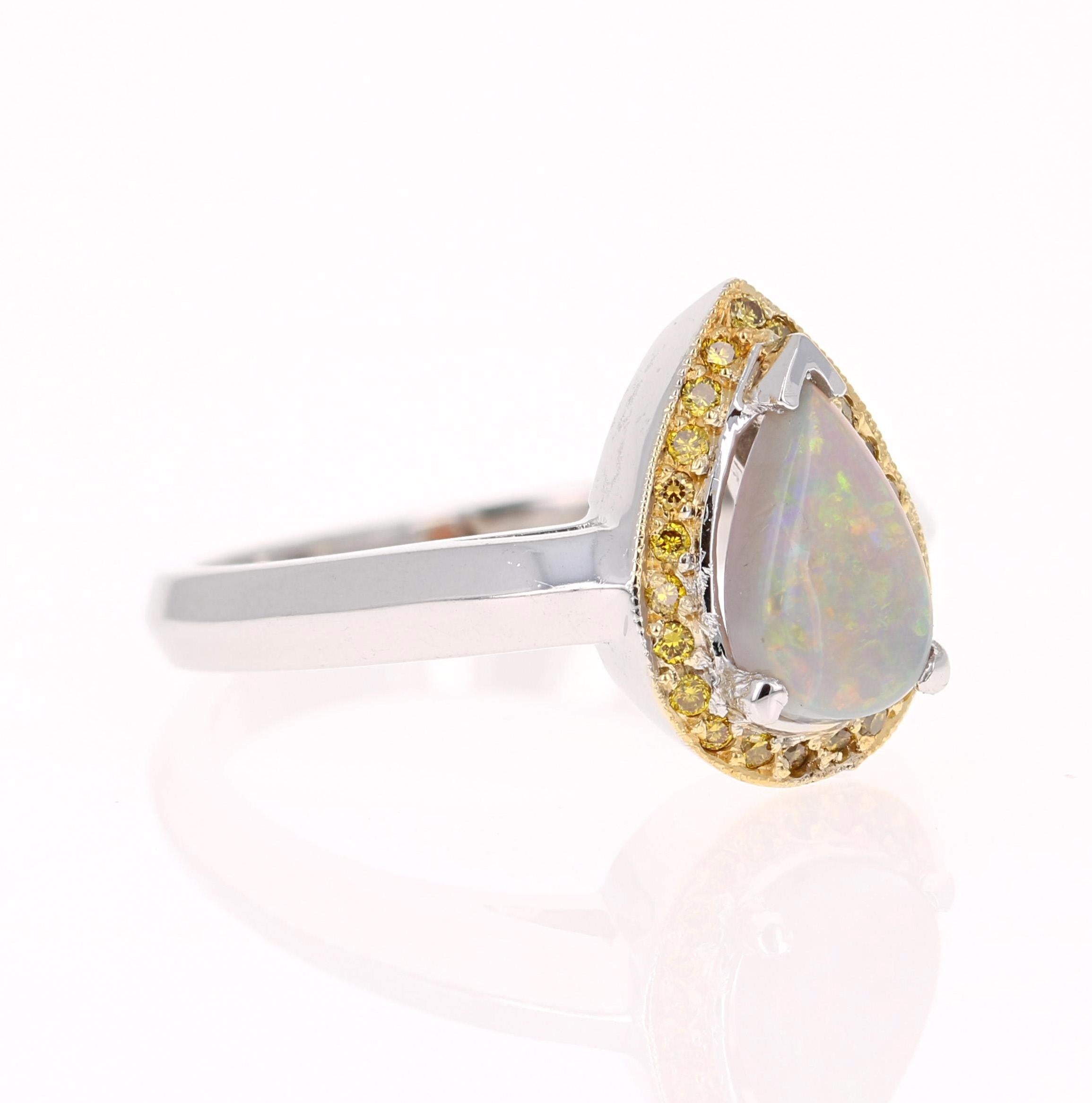 Cute and dainty ring that can be a great addition to anyone's accessory collection!   This ring has a 0.79 Carat Pear Cut Opal that is set in the center of the ring and is surrounded by 23 Yellow Diamonds that weigh 0.13 Carats.  The total weight of