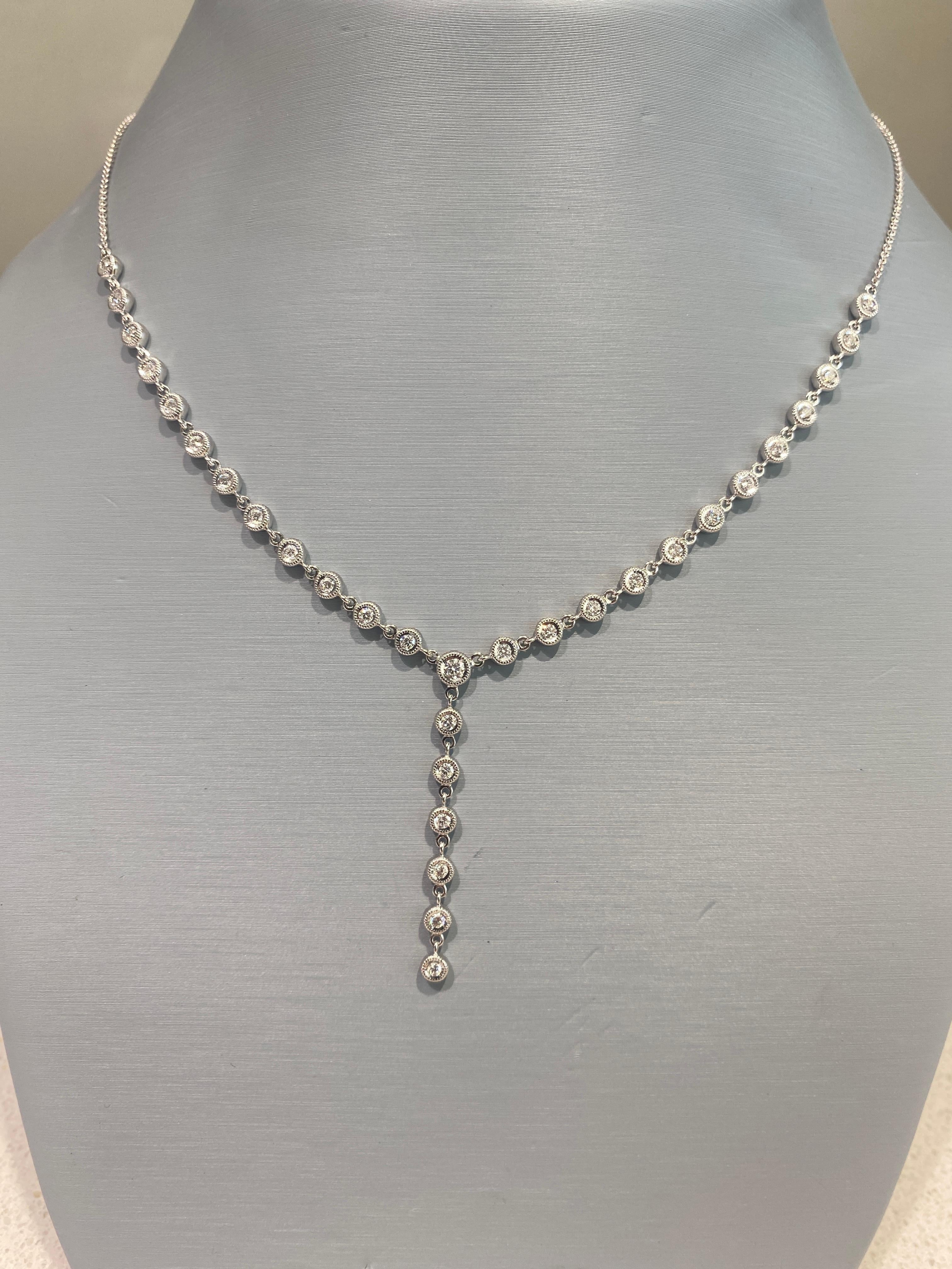 This lariat style necklace from Simon G. features 0.92 carat total weight in bezel set round brilliant cut diamonds set in 18 karat white gold. The chain is 18