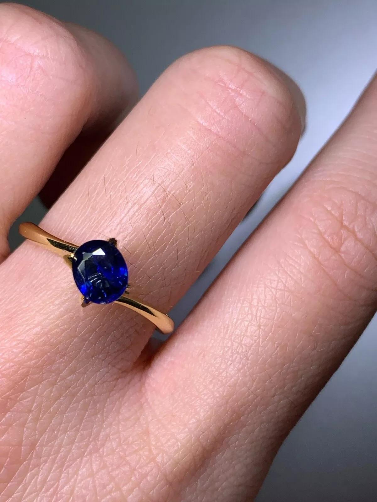 Make a bold statement of love with this 0.92ct Ceylon Sapphire Solitaire Engagement Ring. Crafted from 18ct yellow gold, this ring features a stunning oval-shaped sapphire as the centerpiece. The solitaire setting style is perfect for those who