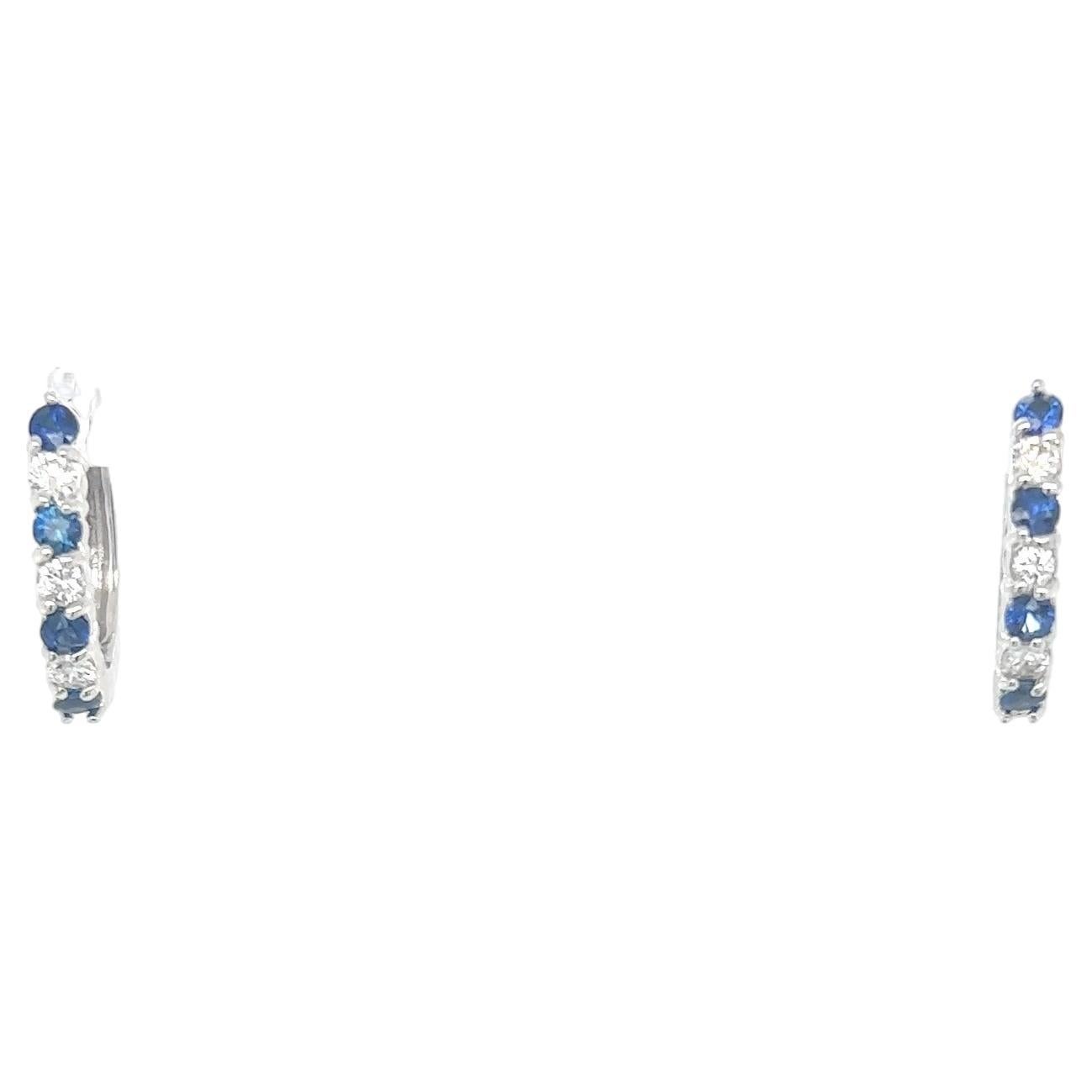 These beautiful earrings have Natural Round Cut Sapphires that weigh 0.61 carats and have Natural Round Cut Diamonds that weigh 0.32 Carats. The total carat weight of the earrings are 0.93 carats. 

They are set in 14 Karat White Gold and weigh