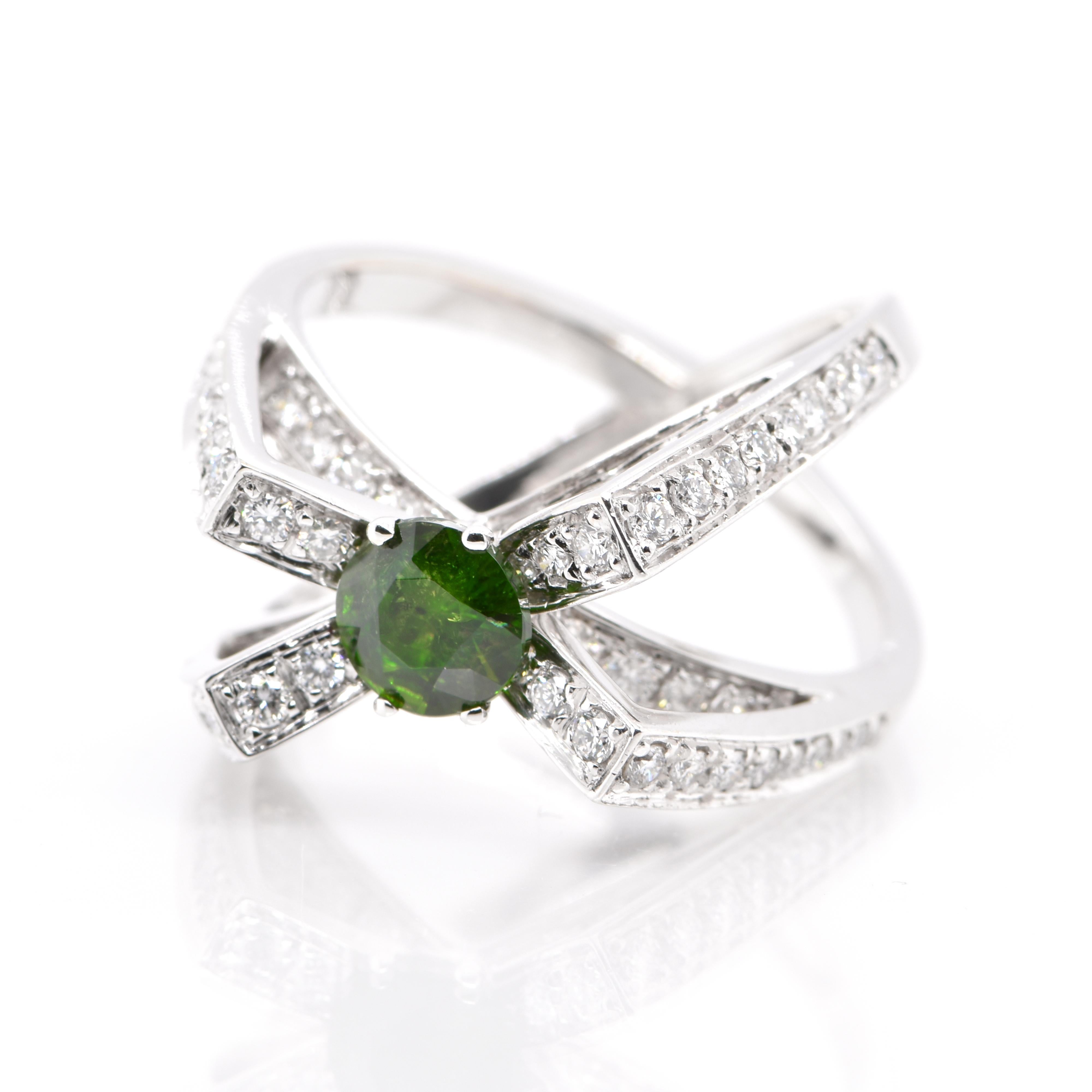 A beautiful Cocktail Ring featuring a 0.92 Carat, Natural Demantoid Garnet and 0.81 Carats of Diamond Accents set in 18 Karat White Gold. Demantoid Garnet's only known source used to be the Ural Mountains in Russia however recent discoveries in