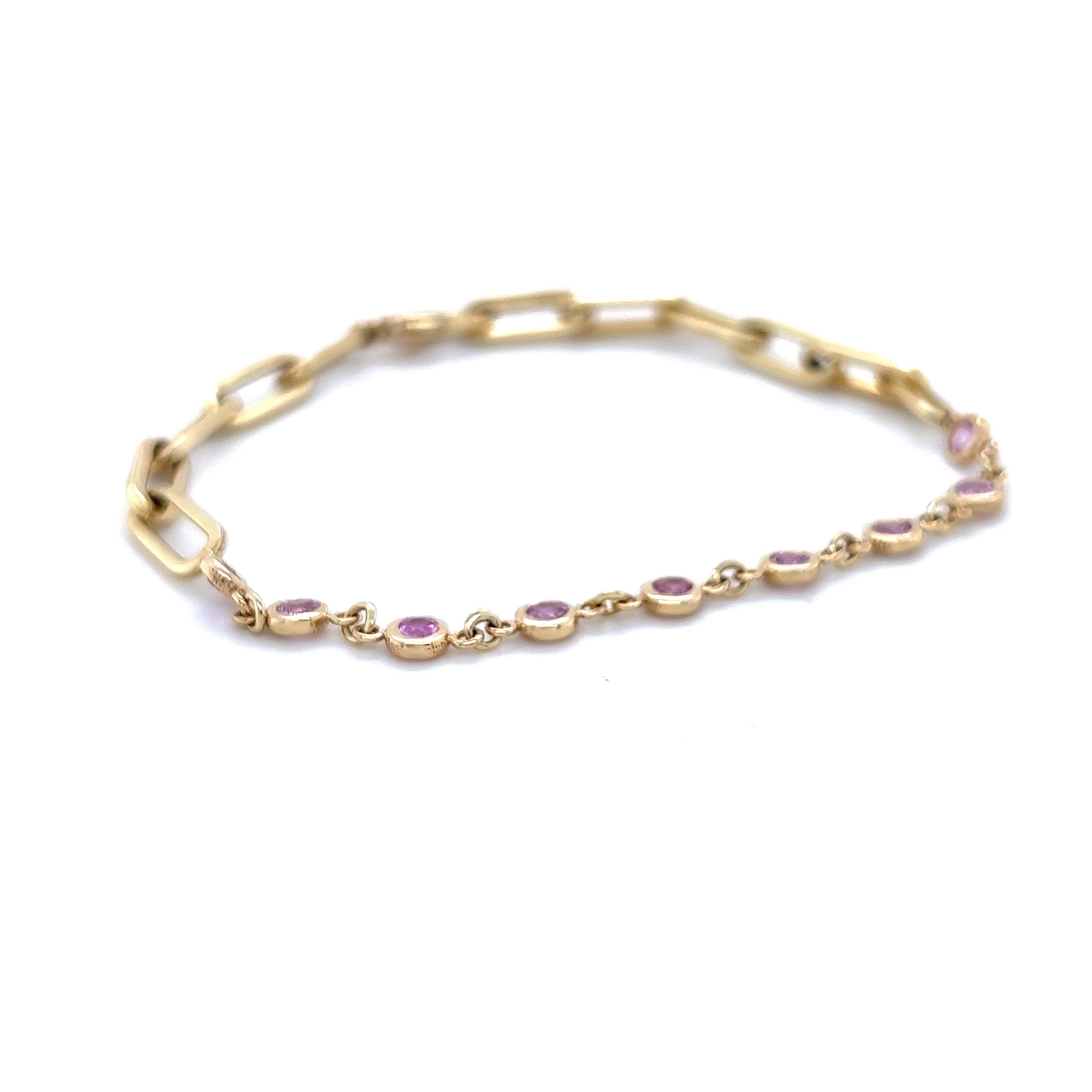 This bracelet has 0.93 carats of Natural Round Cut Pink Sapphires and is approximately 7.5 inches long. 

It is set in 14 Karat Yellow Gold and weighs approximately 5.9 grams

