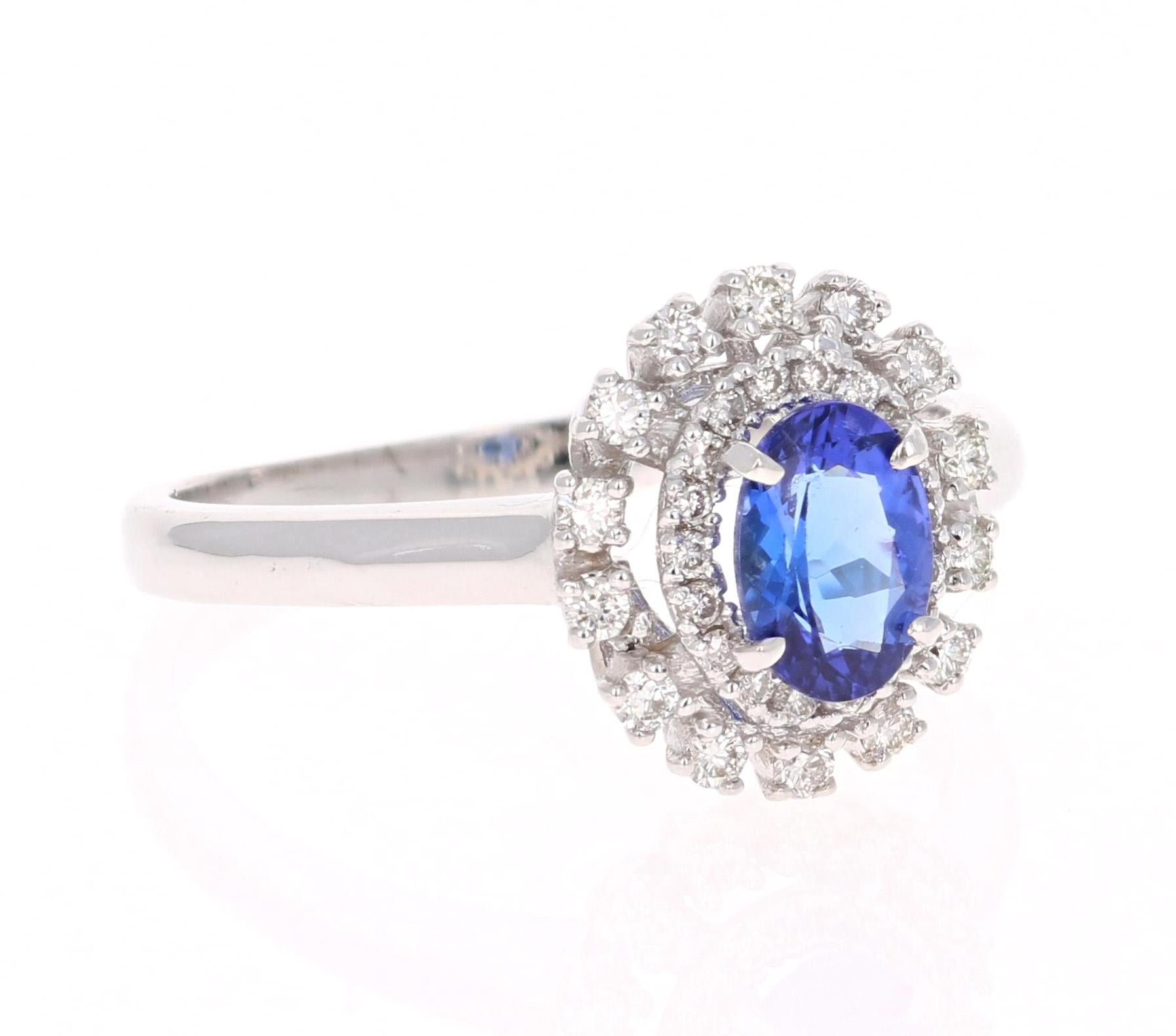 This simple and cute ring has a lovely Oval Cut Tanzanite that weighs 0.65 Carats. It is surrounded by 32 Round Cut Diamonds that weigh 0.28 Carats. The clarity and color of the diamonds are VS-H. 

The ring is in 14 Karat White Gold and weighs