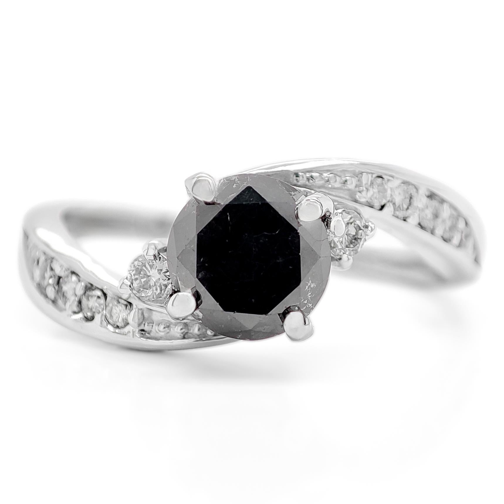 FOR US CUSTOMER NO VAT!

This striking piece showcases a remarkable 0.93 carat fancy black diamond, which has been enhanced to achieve its unique and deep black color.

Complementing the bold black diamond are 12 round brilliant-cut diamonds,
