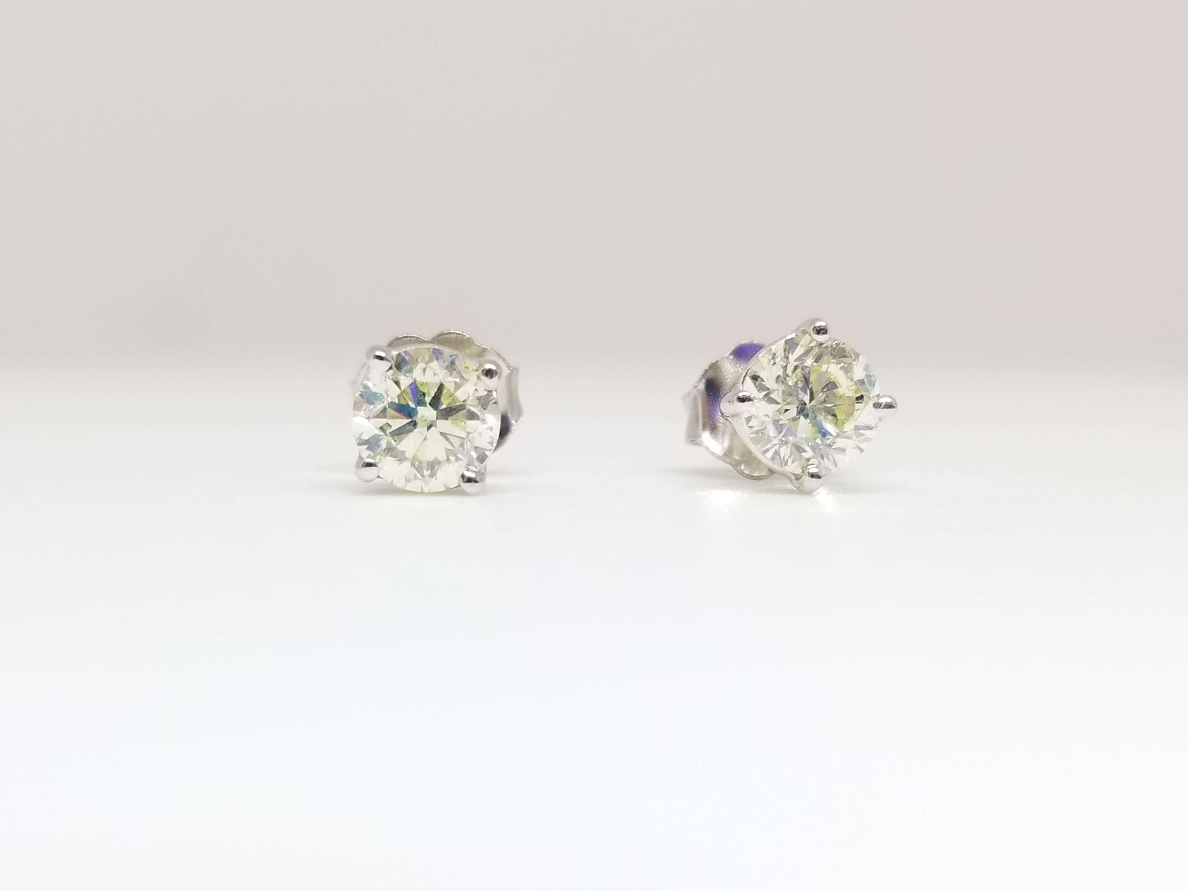 Natural Round Diamond Studs set in 4 prong push back 14k white gold 0.94 carats total weight. Color I-J, Clarity SI.
