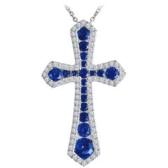 0.94 Carat Vivid Blue Sapphire and Natural Diamond Cross Pendant in 18k White