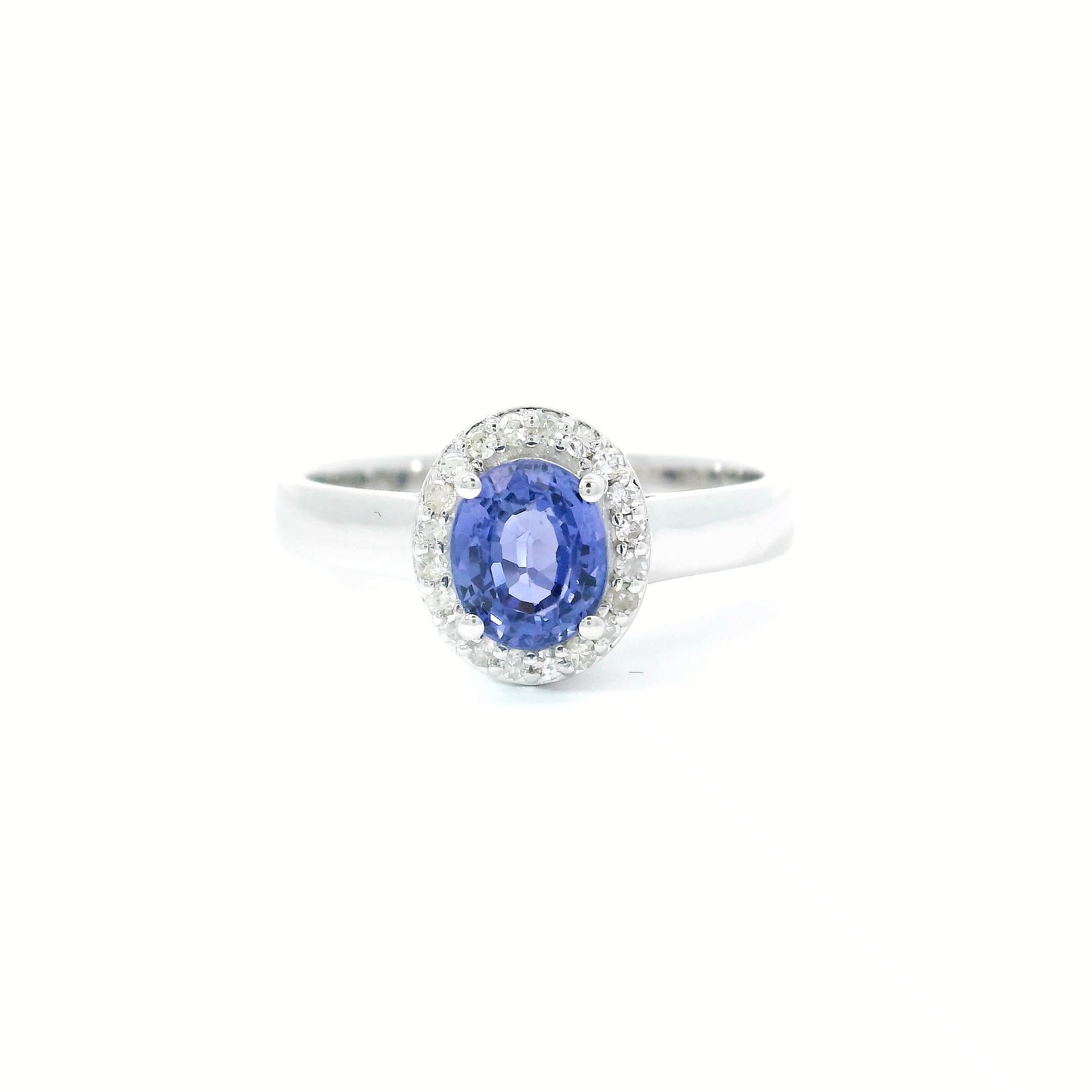 18kt white gold Sapphire Ring
  
  Gold colour & karat: White gold 18kt
  Weight: 3.79 grams
  
  Set with-
  Stone type: Diamond
  Shape: Oval 
  Carat: 0.94 cts
  Colour: Blue Colour
  
  Surrounding Stones: Diamonds
 1) White Diamonds
  Carat