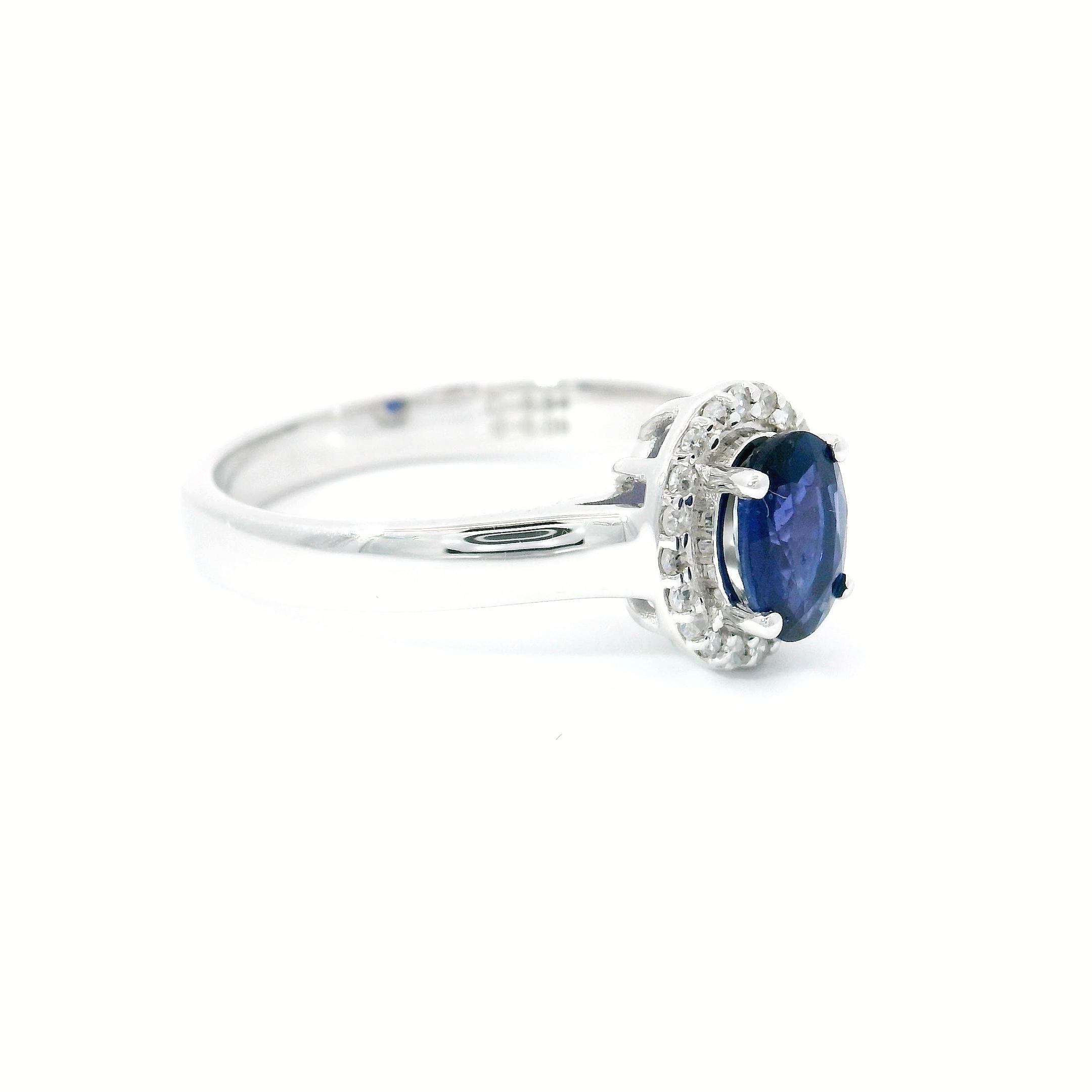 18kt white gold Sapphire Ring
  
  Gold colour & karat: White gold 18kt
  Weight: 3.83 grams
  
  Set with-
  Stone type: Diamond
  Shape: Oval 
  Carat: 0.94 cts
  Colour: Blue Colour
  
  Surrounding Stones: Diamonds
 1) White Diamonds
  Carat