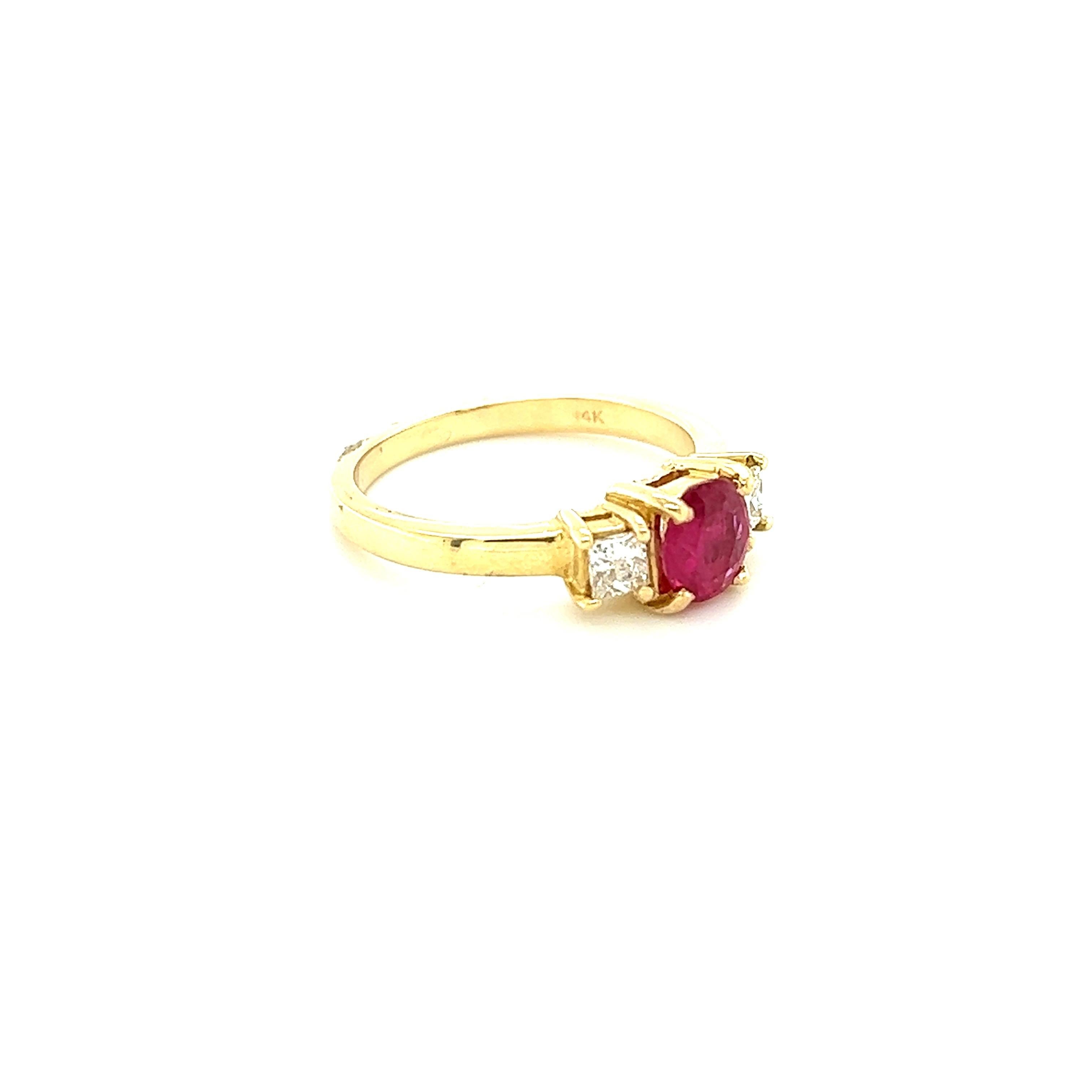 This Ring has a Oval Cut Natural Ruby that measures 6 mm x 5 mm and weighs 0.67 carats and it has 2 Princess Cut Diamonds that weigh 0.27 carats. The total carat weight of the ring is 0.94 carats. 

The ring is casted in 14K Yellow Gold and weighs
